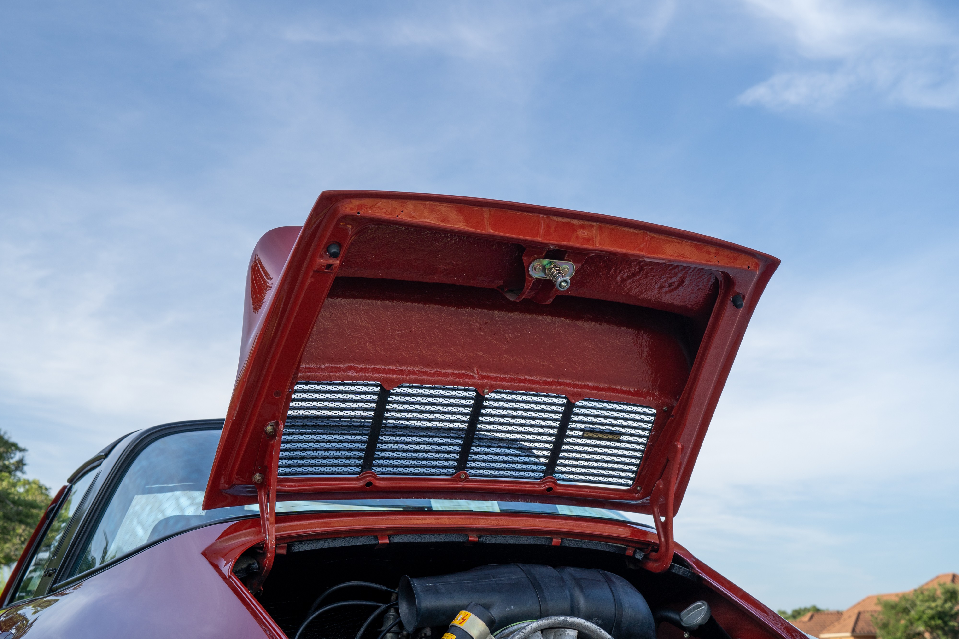 Engine cover on a 1974 Porsche 911 Carrera Targa in Peru Red over Black.