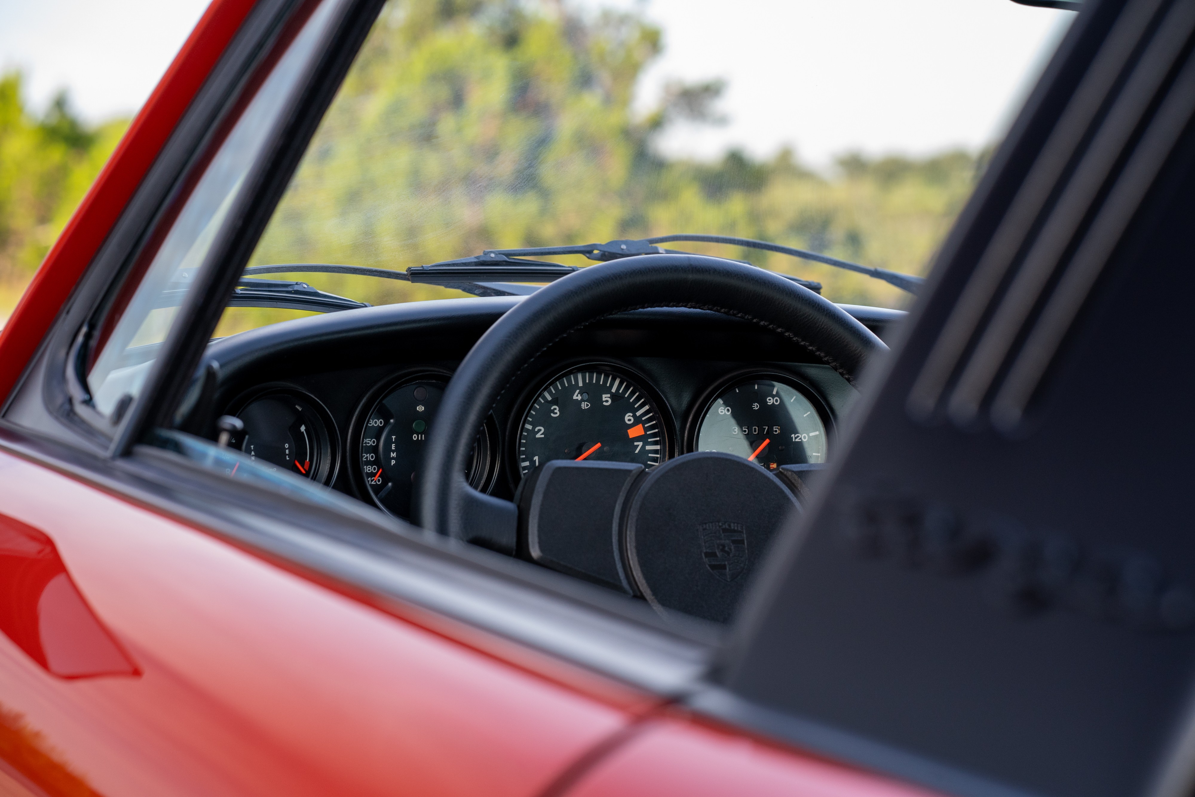 Gauges in a 1974 Porsche 911 Carrera Targa in Peru Red over Black.