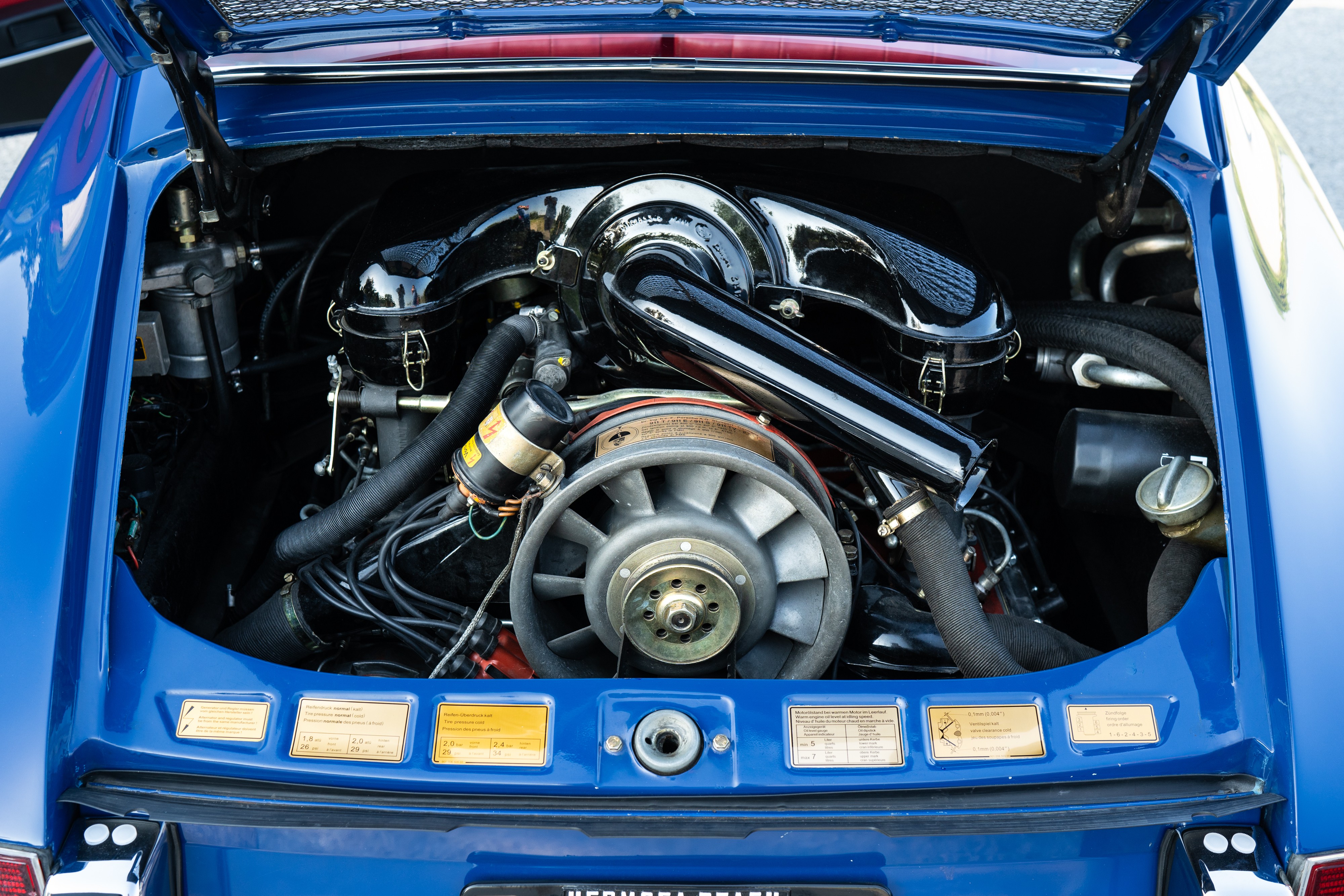 Engine bay of a 1969 Porsche 911S in Ossi Blue over Red.