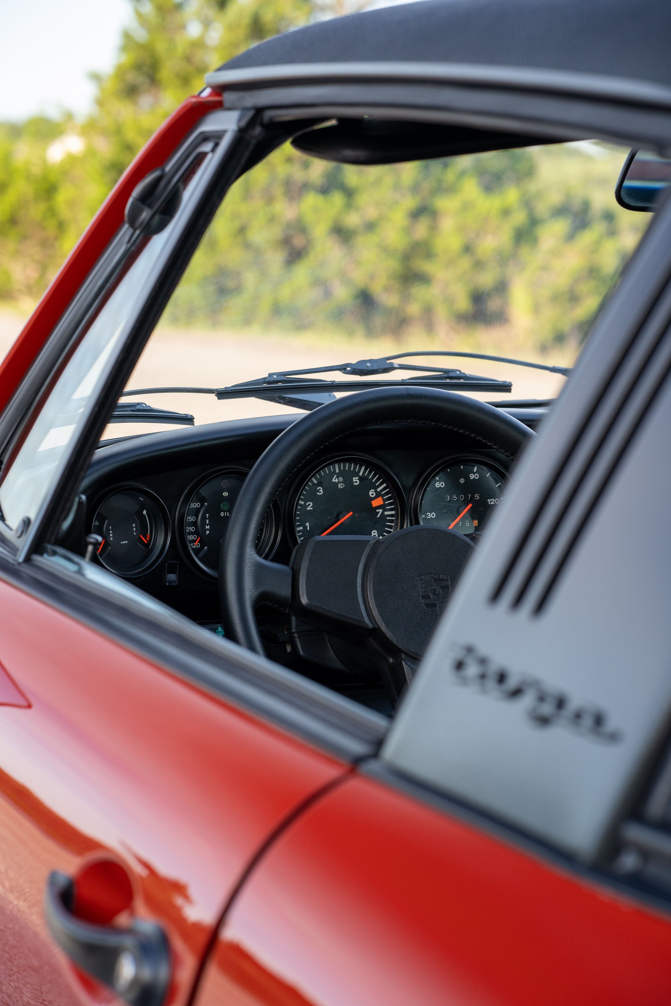 Gauges in a 1974 Porsche 911 Carrera Targa in Peru Red over Black.