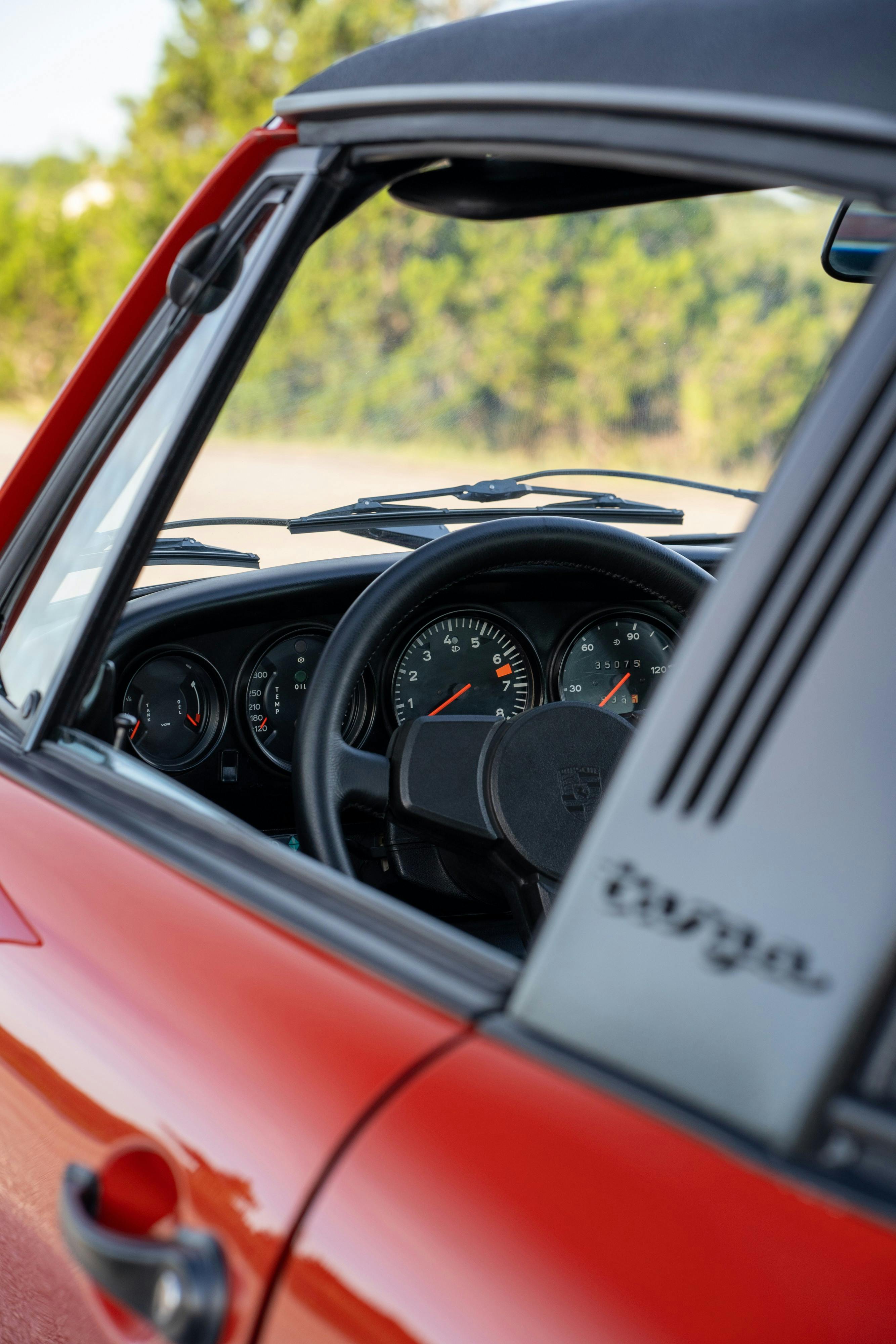Gauges in a 1974 Porsche 911 Carrera Targa in Peru Red over Black.