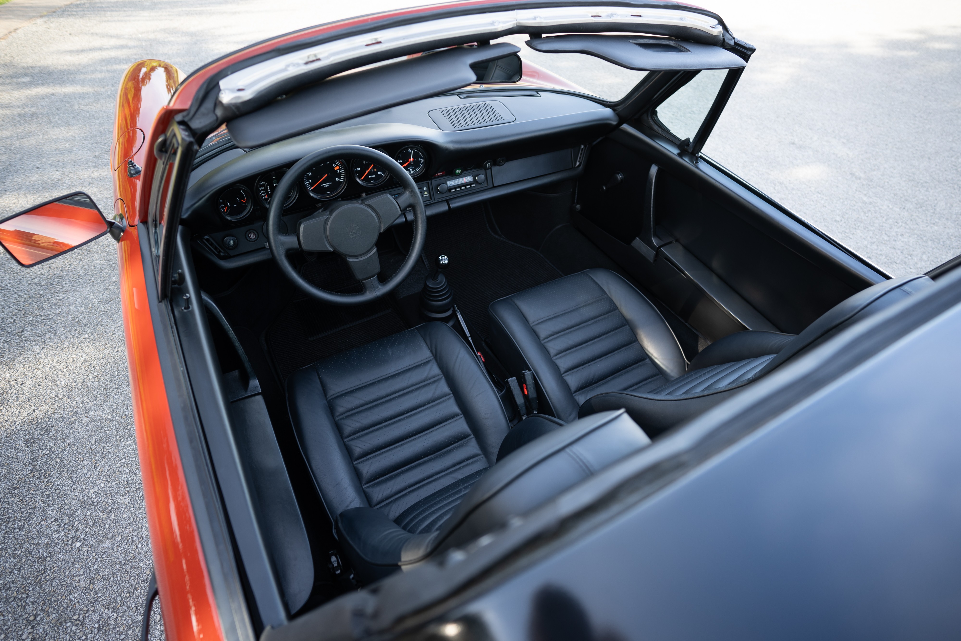 Interior of a 1974 Porsche 911 Carrera Targa in Peru Red over Black.