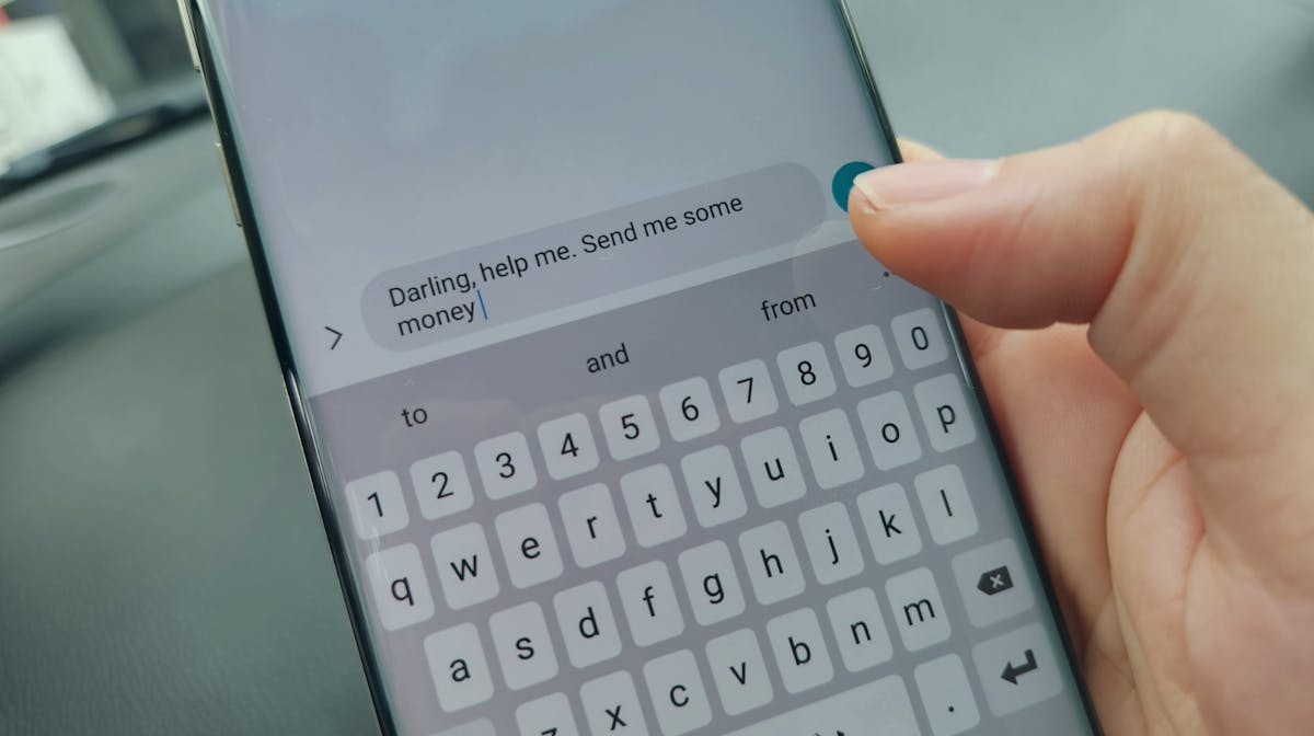Smartphone showing a message asking for money, illustrating a common romance scam scenario