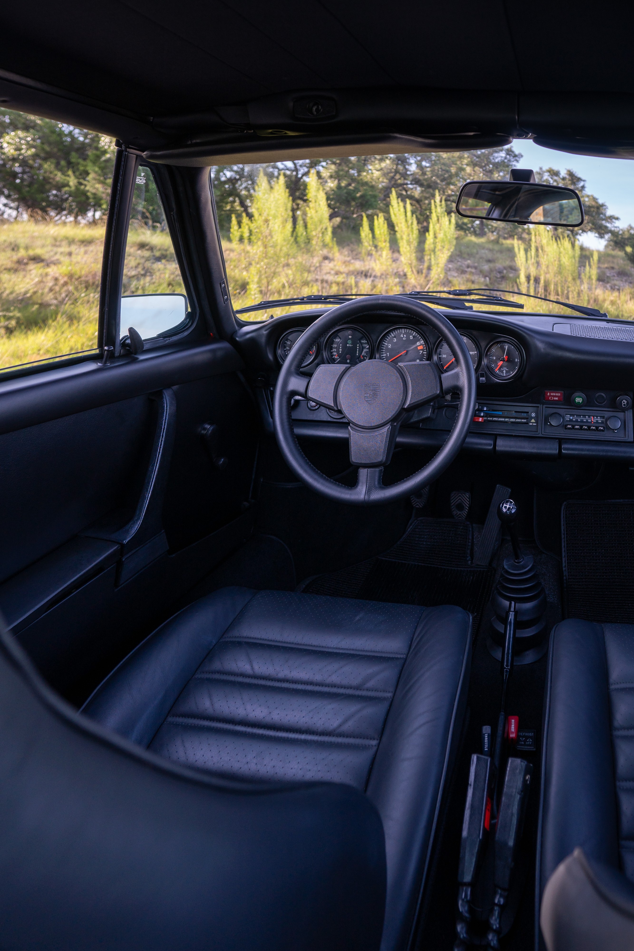 Interior of a 1974 Porsche 911 Carrera Targa in Peru Red over Black.