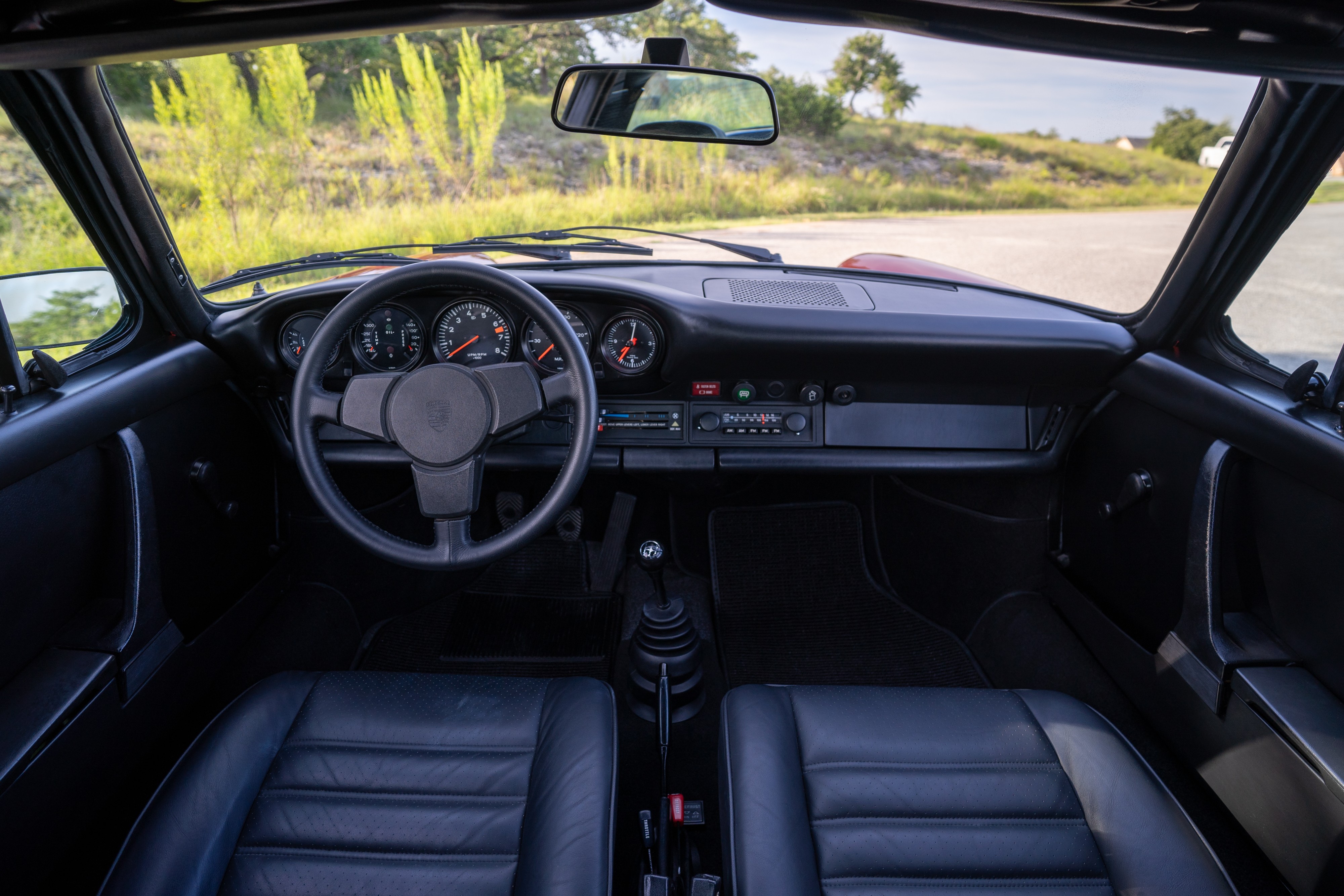 Interior of a 1974 Porsche 911 Carrera Targa in Peru Red over Black.