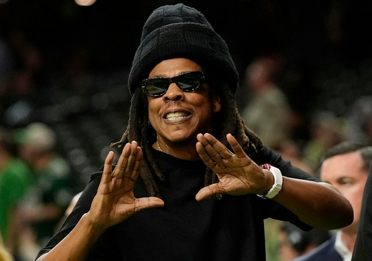 Jay-Z gestures from the sidelines prior to the NFL Super Bowl 59 football game,