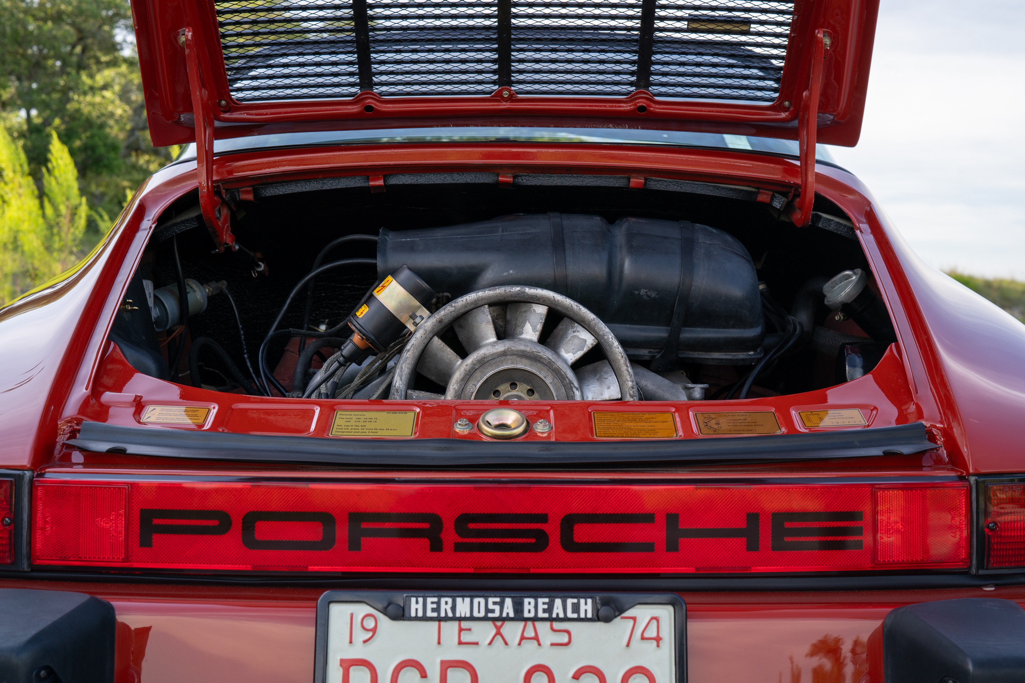 Engine bay of a 1974 Porsche 911 Carrera Targa in Peru Red over Black.