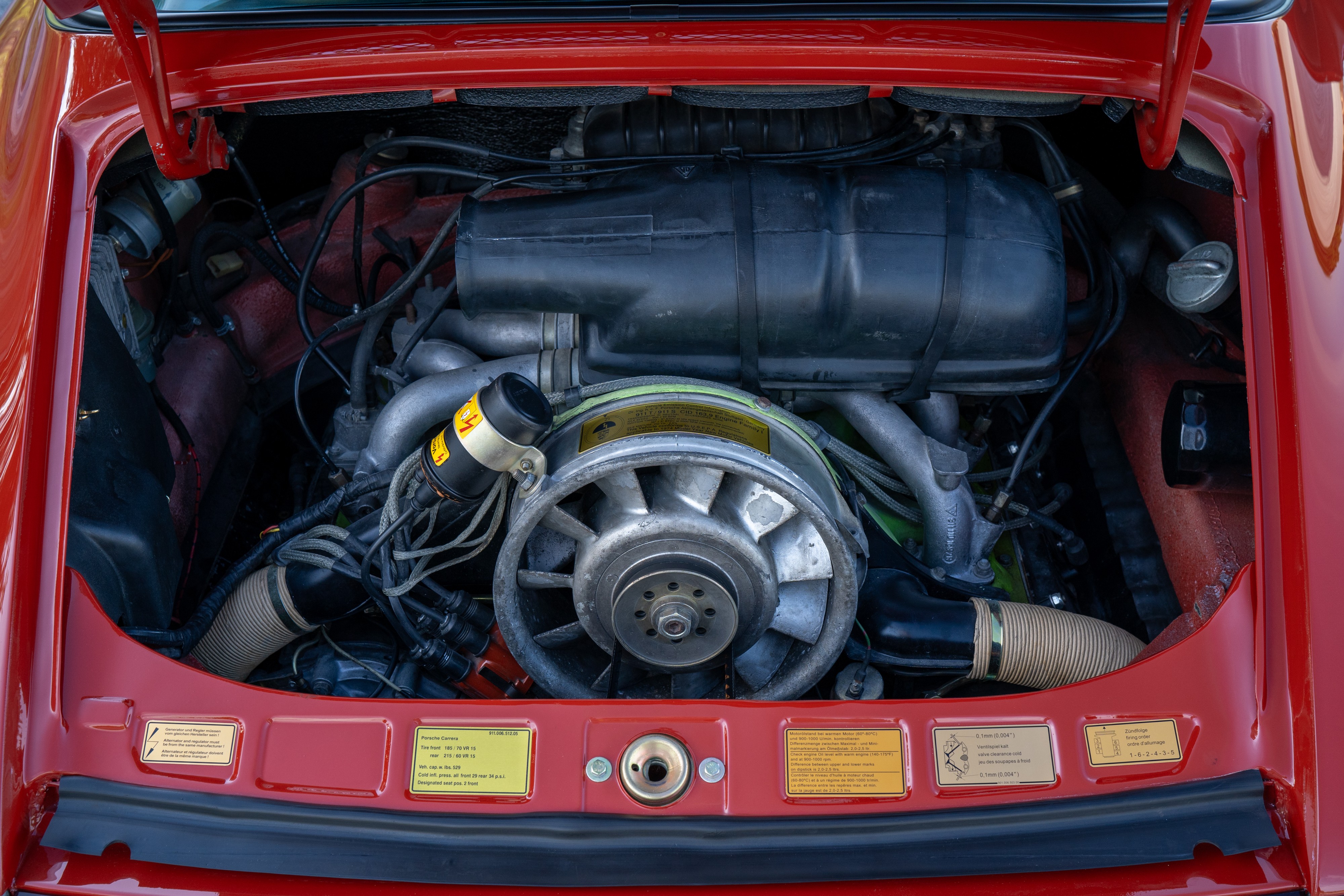 Engine bay of a 1974 Porsche 911 Carrera Targa in Peru Red over Black.