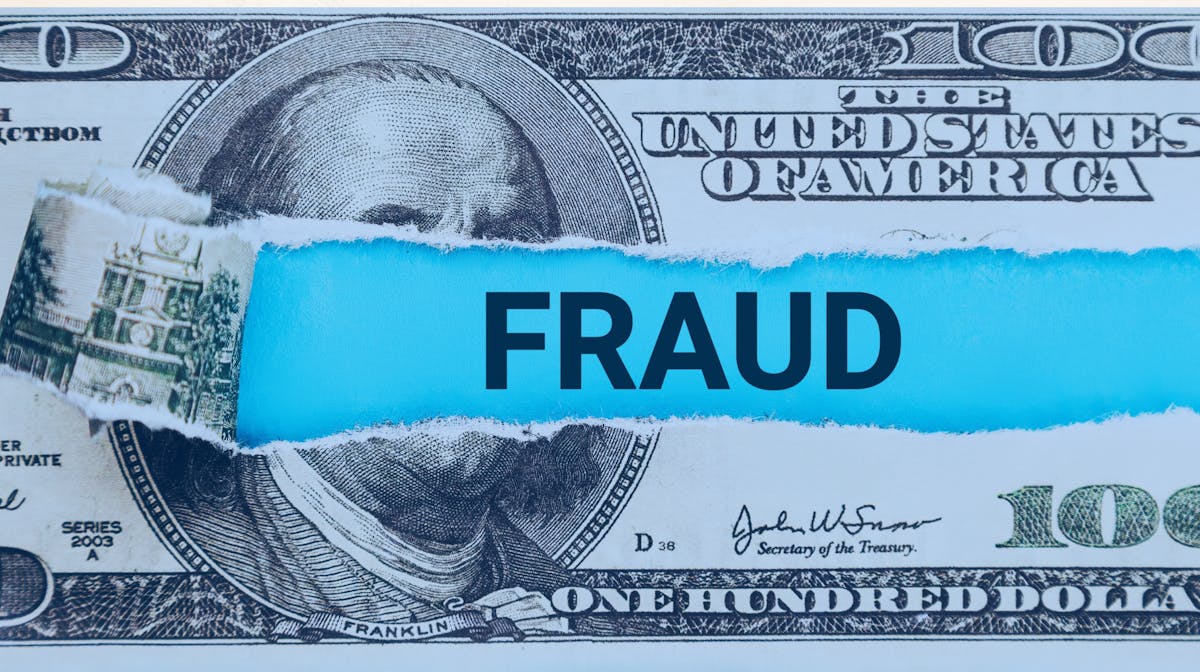 U.S. $100 bill with the word “FRAUD”, illustrating tax fraud and identity theft risks during tax season.