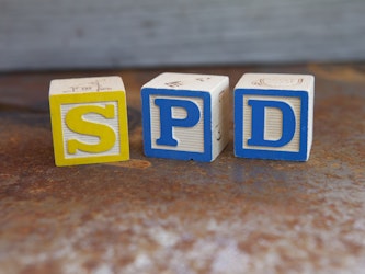 letter blocks that spell out S P D for sensory processing disorder