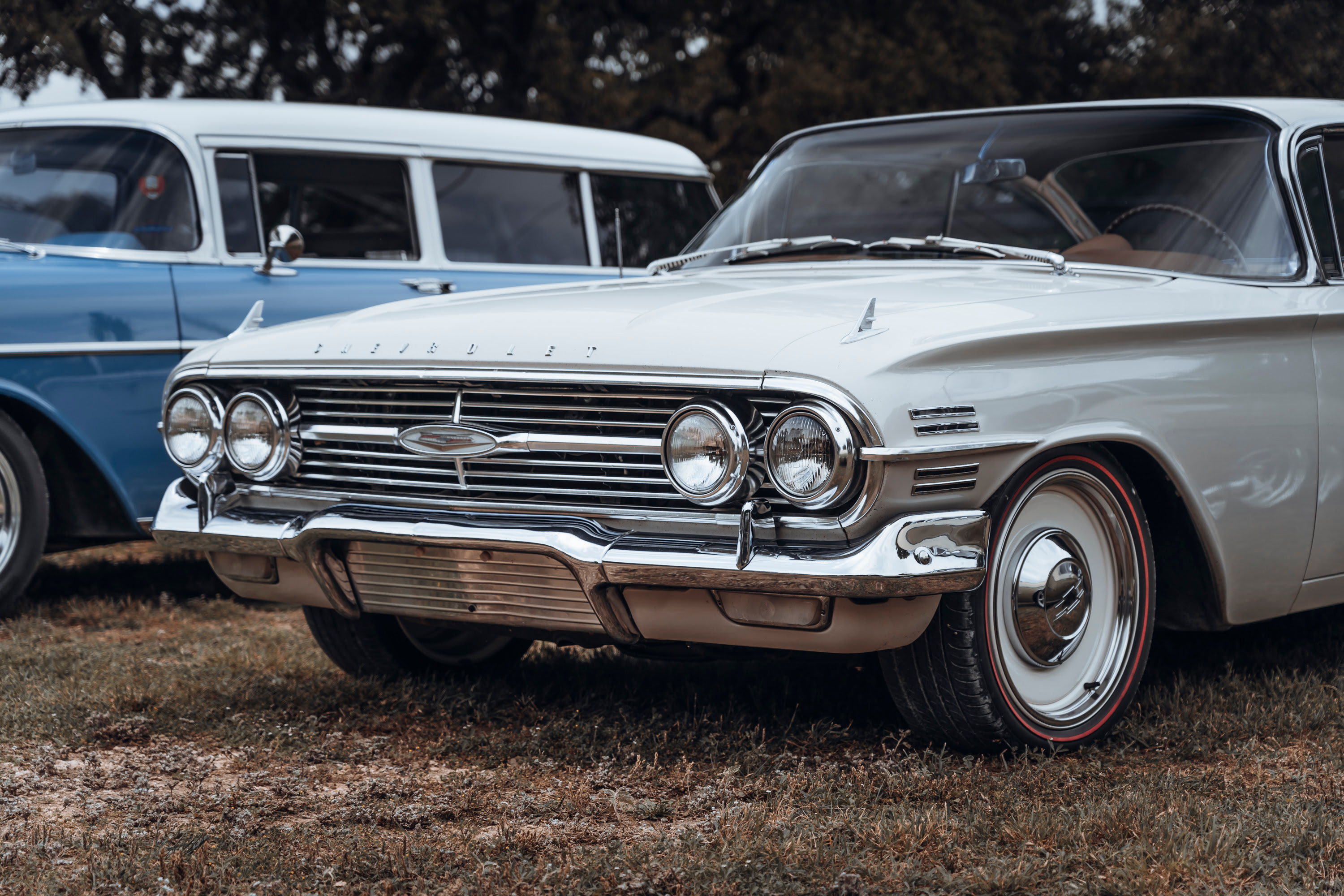 White Chevy with red stripe tires.