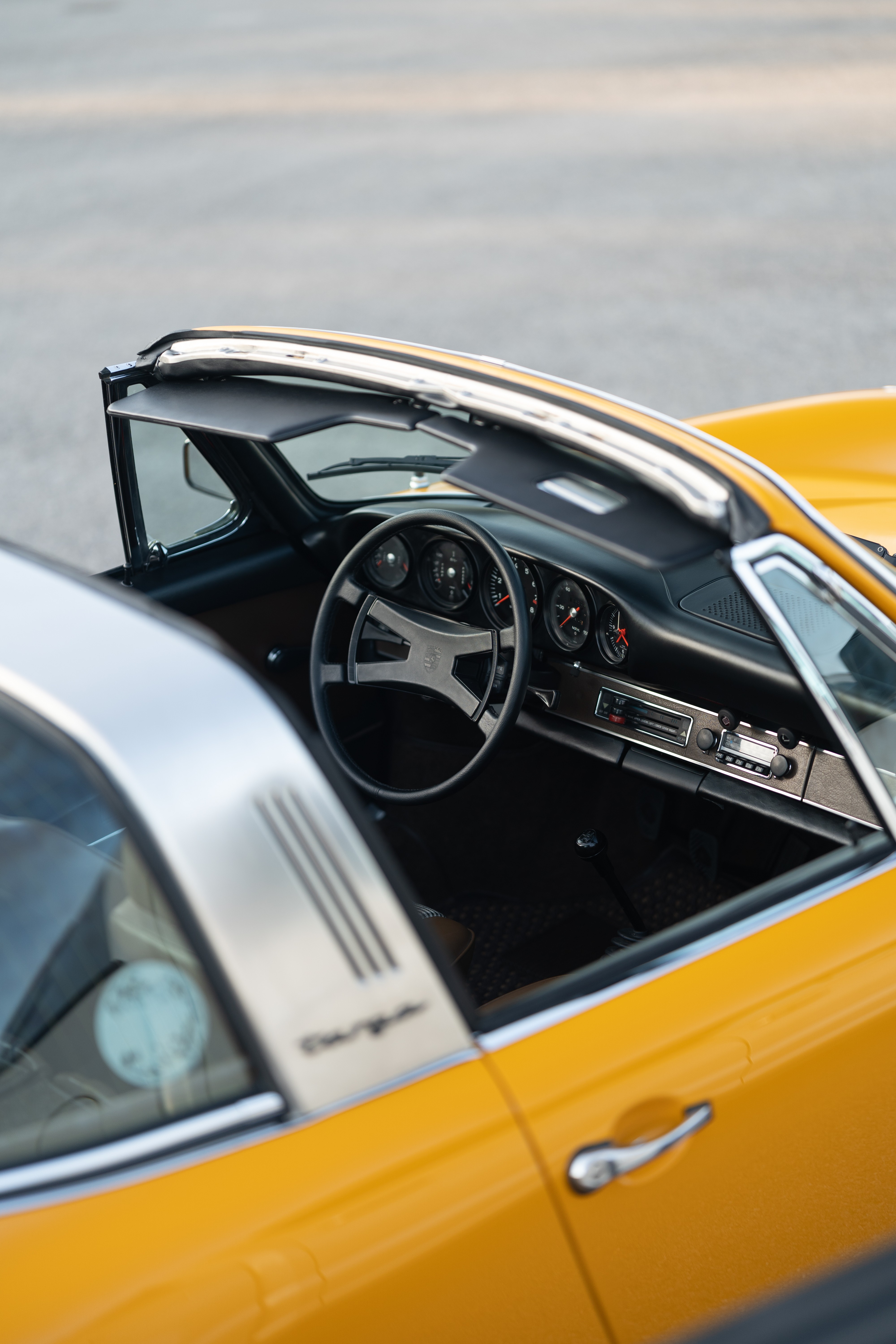 A Signal Yellow 1973 Porsche 911S Targa with brown interior in Austin, TX.