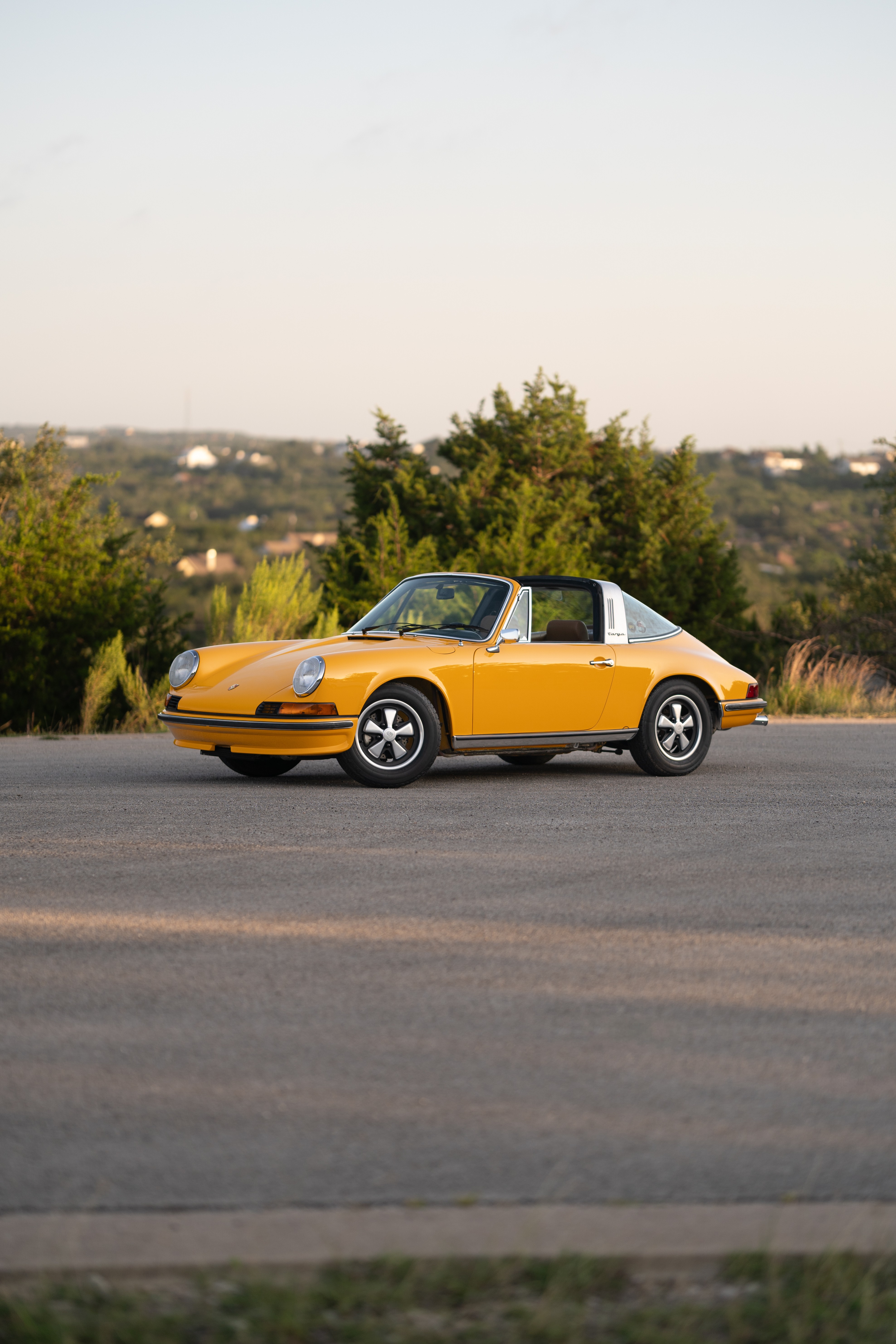 A Signal Yellow 1973 Porsche 911S Targa with brown interior in Austin, TX.