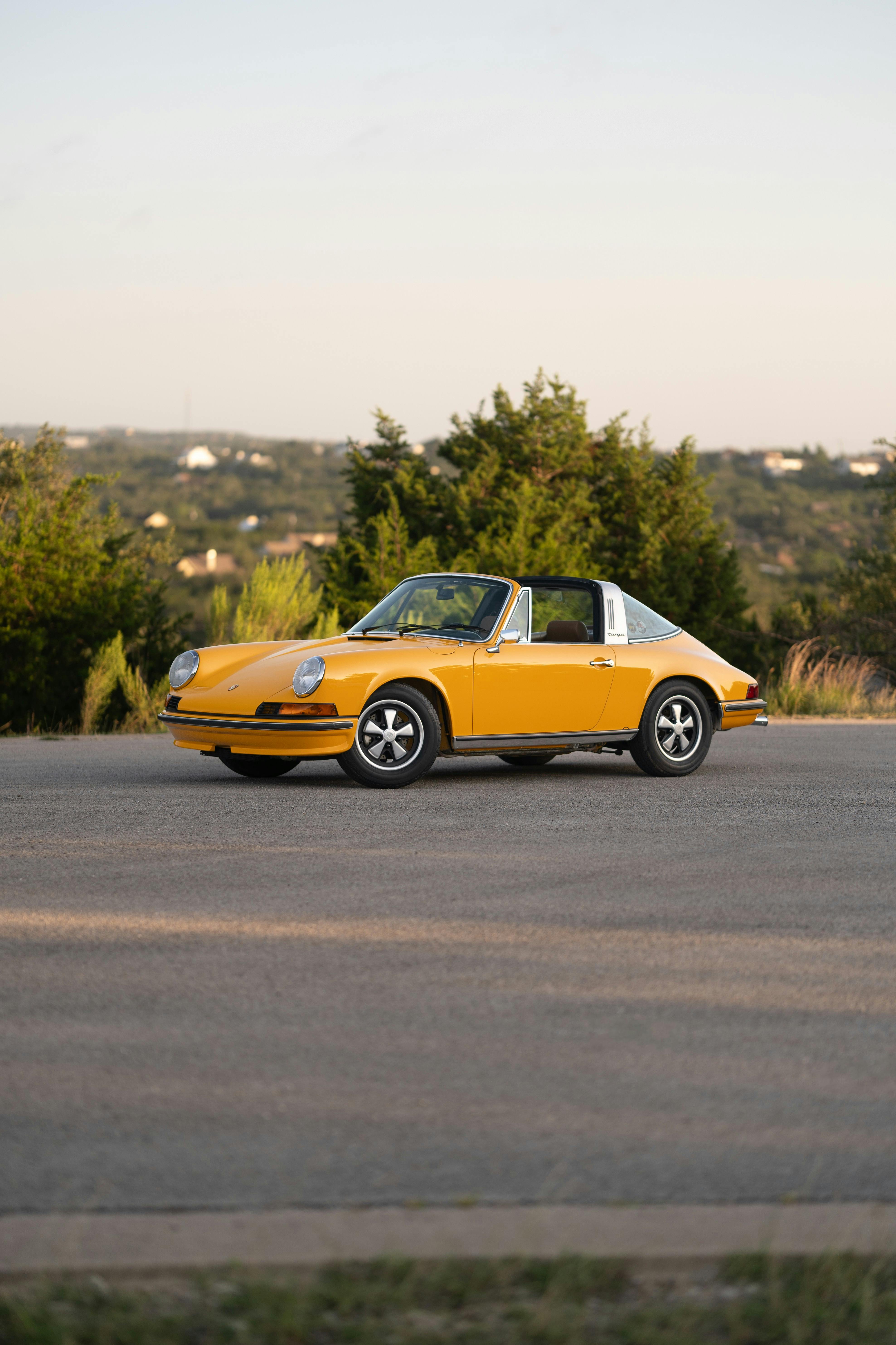A Signal Yellow 1973 Porsche 911S Targa with brown interior in Austin, TX.