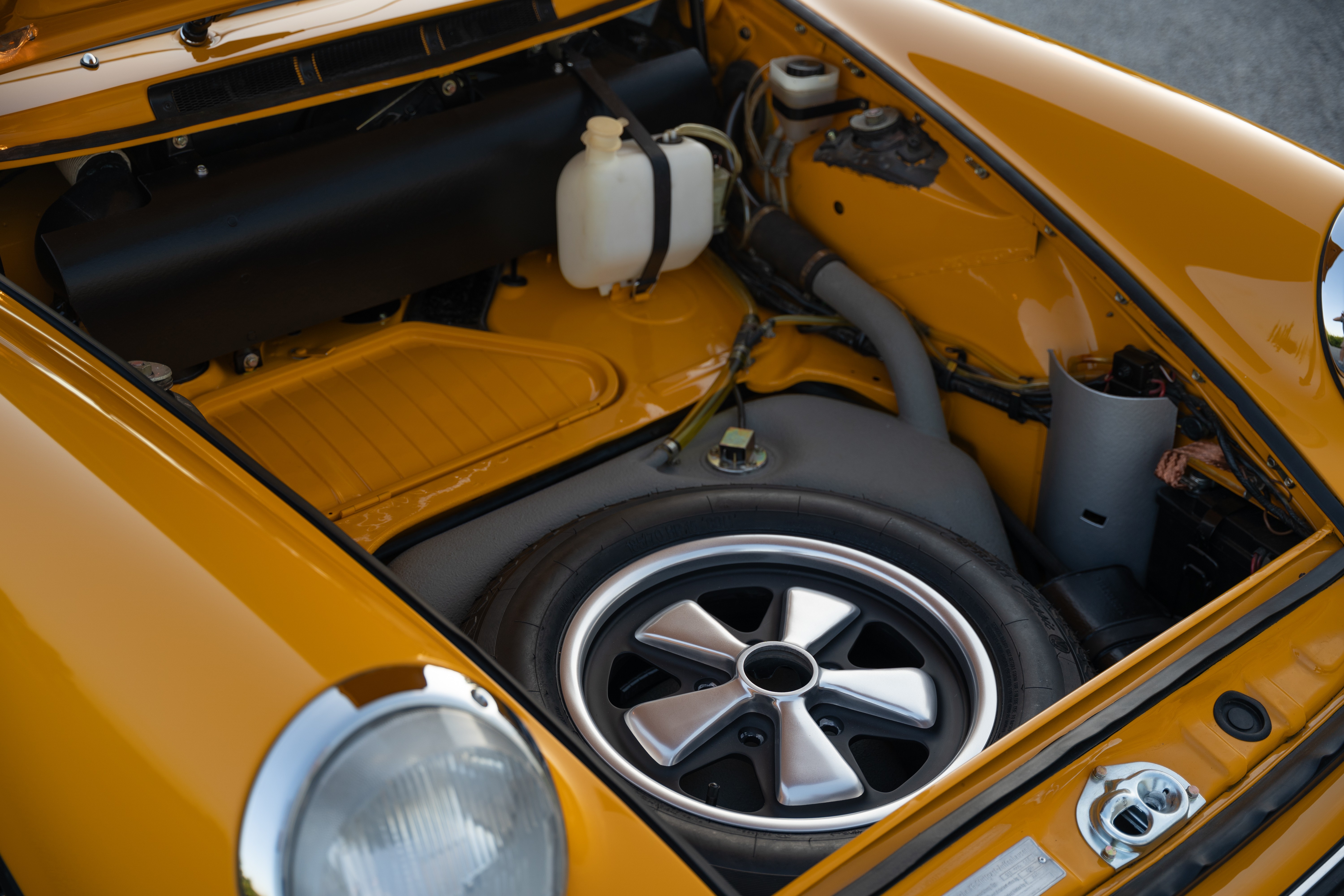 A Signal Yellow 1973 Porsche 911S Targa with brown interior in Austin, TX.