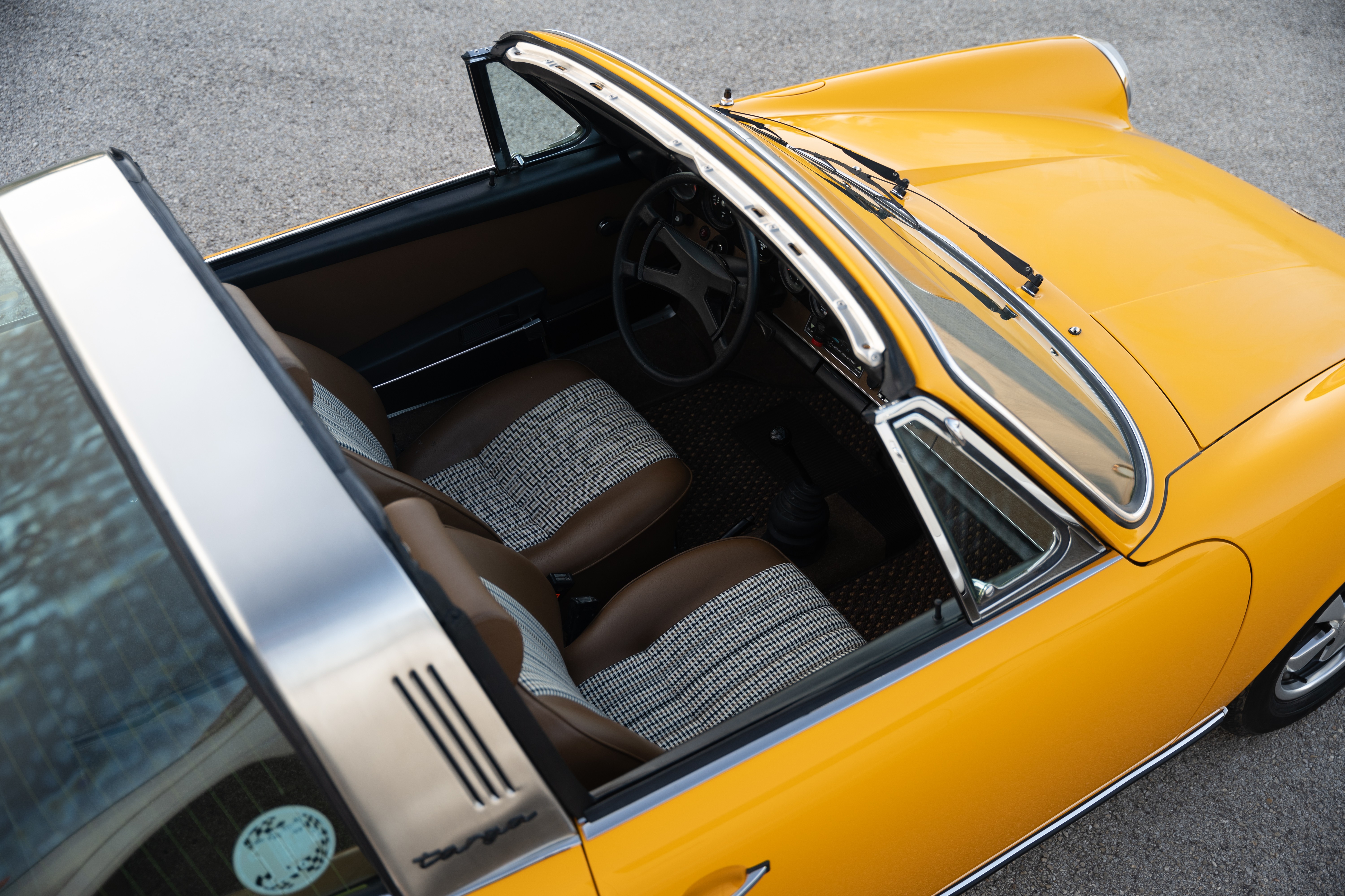 A Signal Yellow 1973 Porsche 911S Targa with brown interior in Austin, TX.