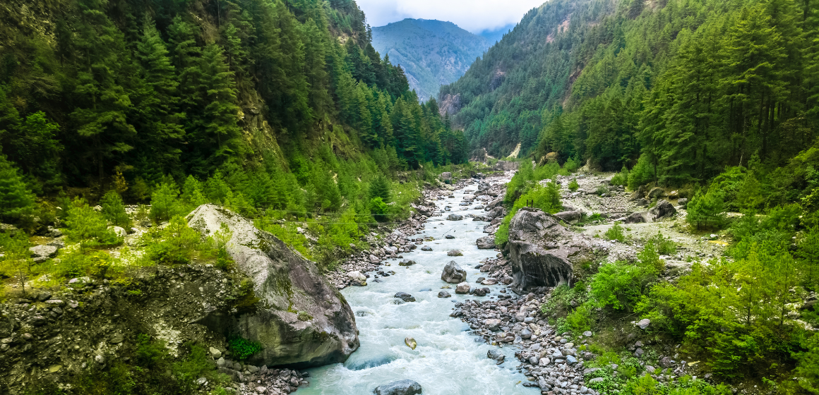 Lush-landscape-and-river-along-Everest-Base-Camp-trail-in-summer---The-Adventure-People.png