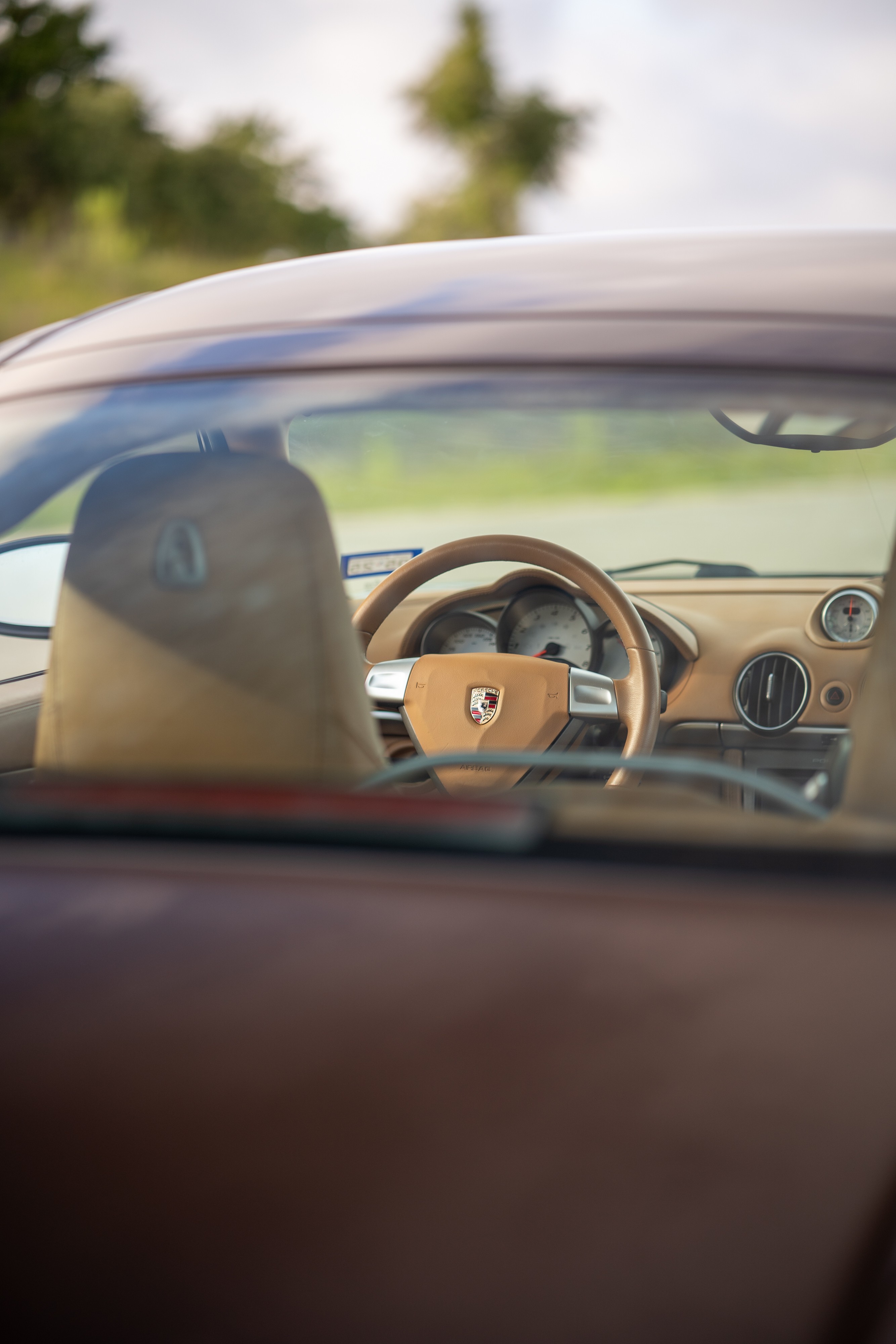 Interior of a 2008 Porsche Cayman S in Macadamia Metallic on Brown.