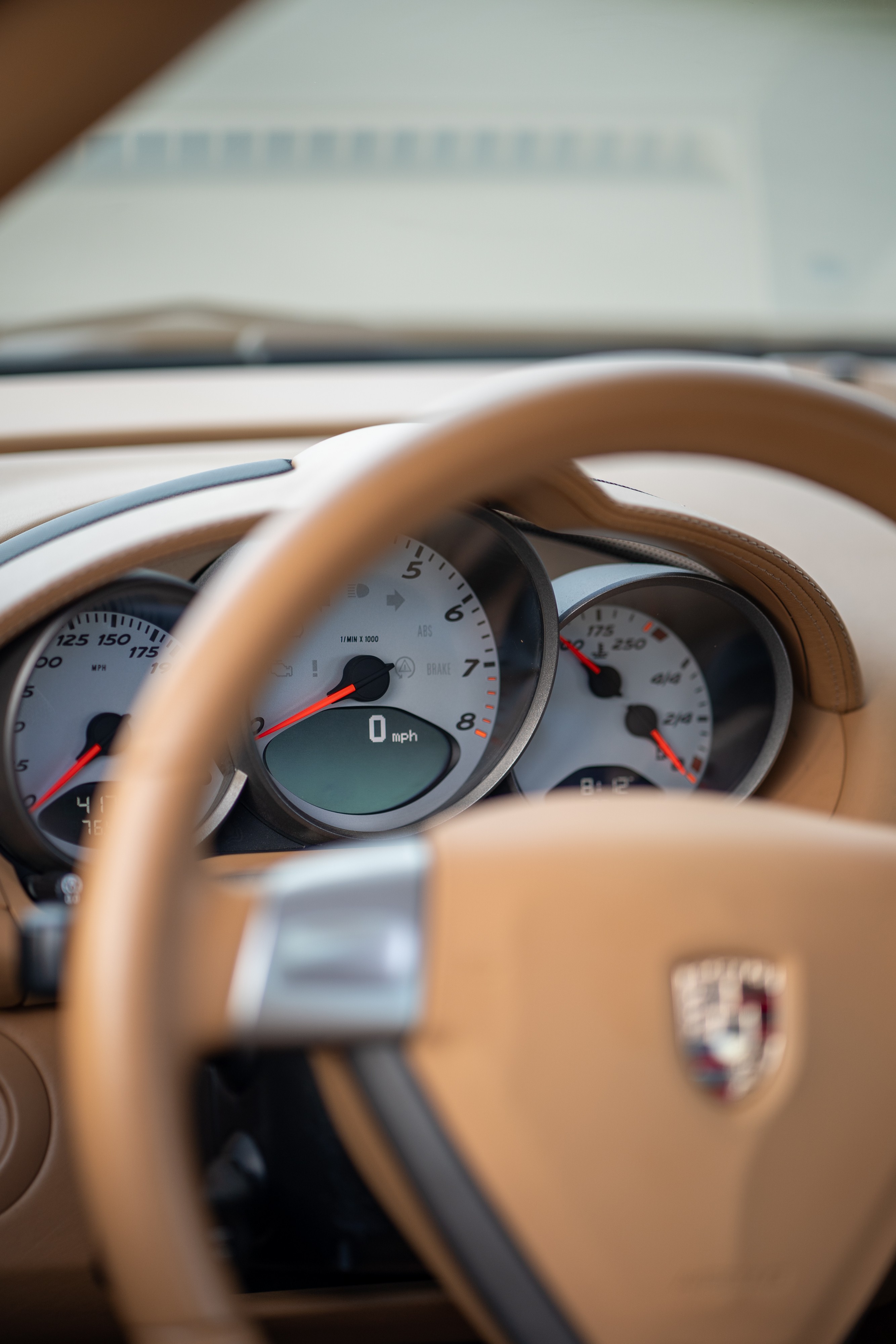 Interior of a 2008 Porsche Cayman S in Macadamia Metallic on Brown.