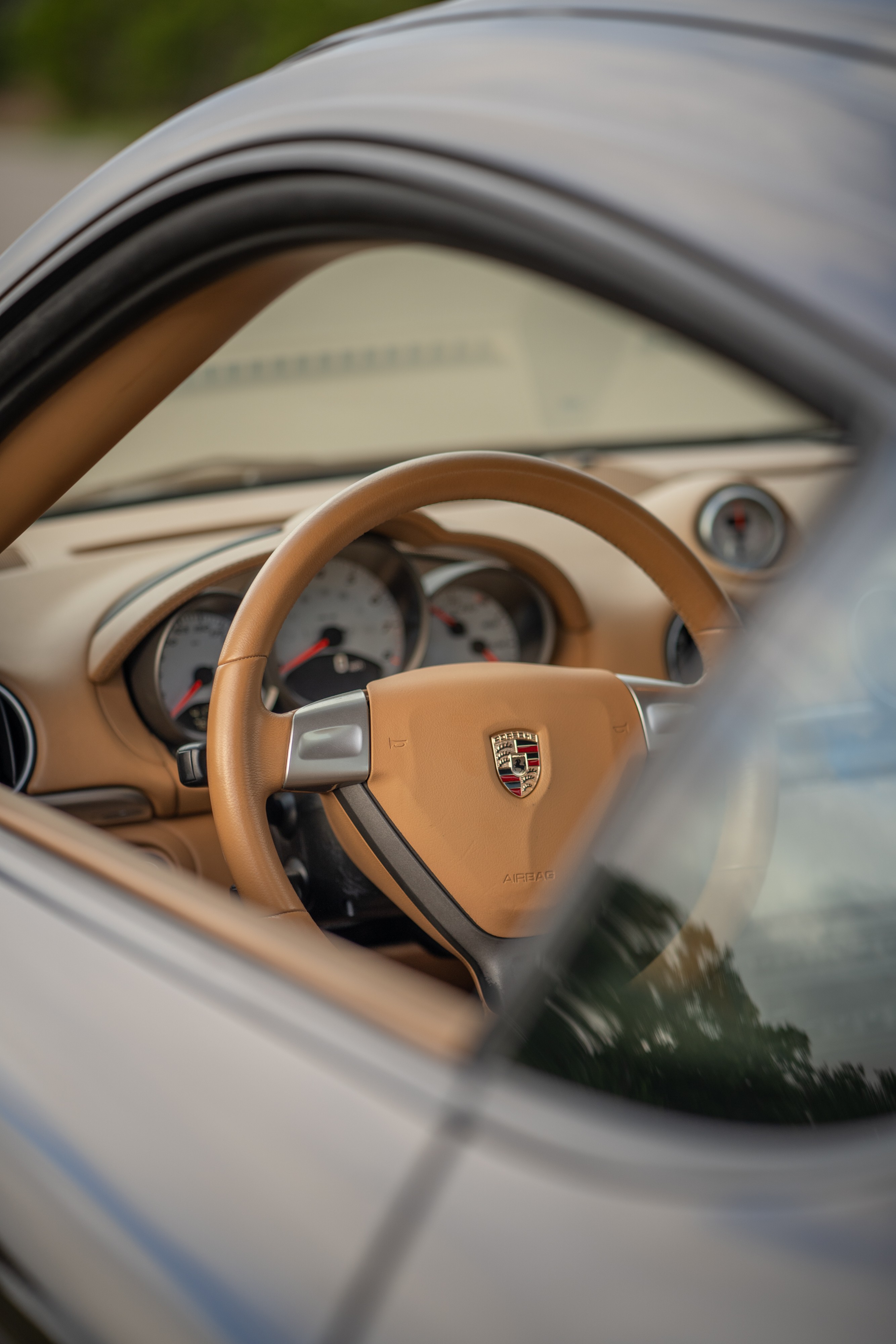 Interior of a 2008 Porsche Cayman S in Macadamia Metallic on Brown.