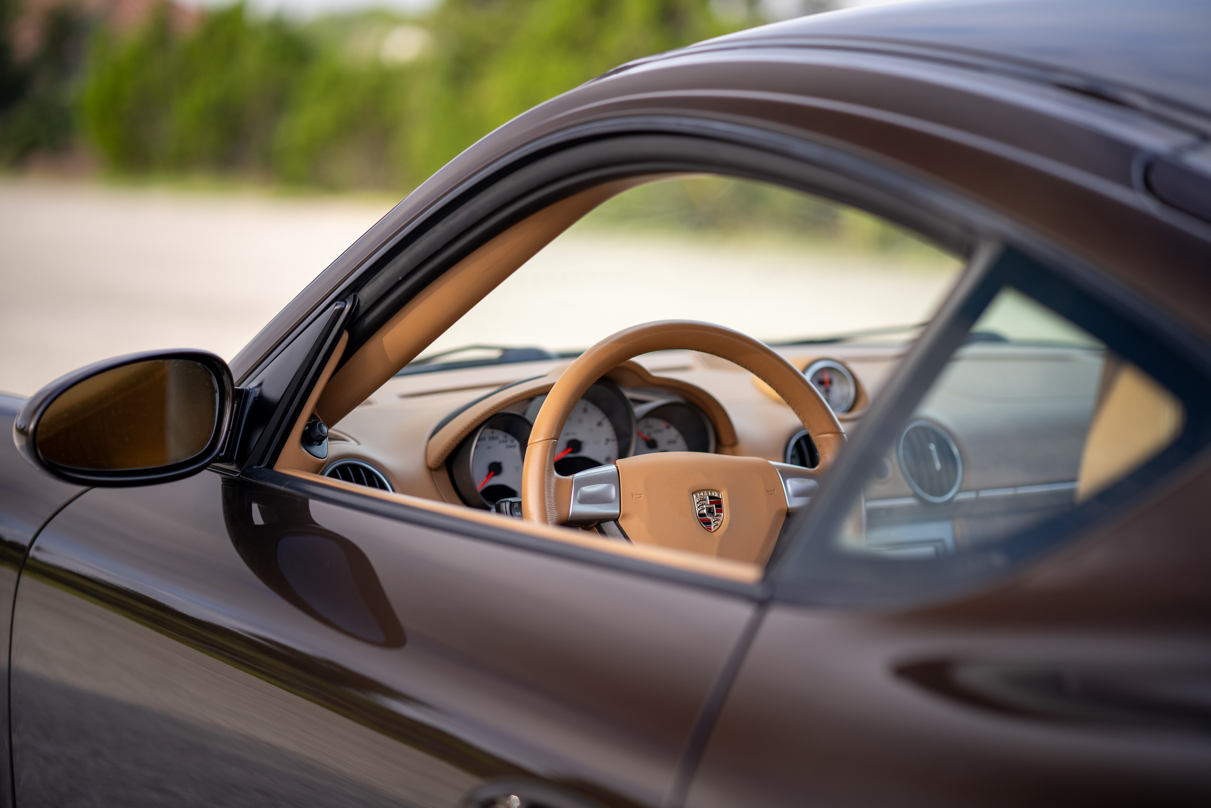 Interior of a 2008 Porsche Cayman S in Macadamia Metallic on Brown.