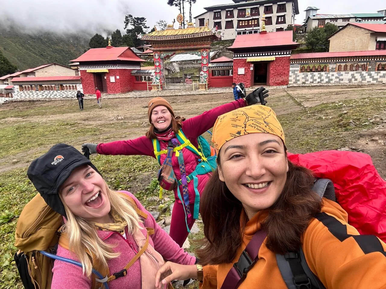 Sarala-with-clients-in-front-of-Tengboche-Monastery-the-lady-in-yellow-band-on-her-head-is-sarala.png