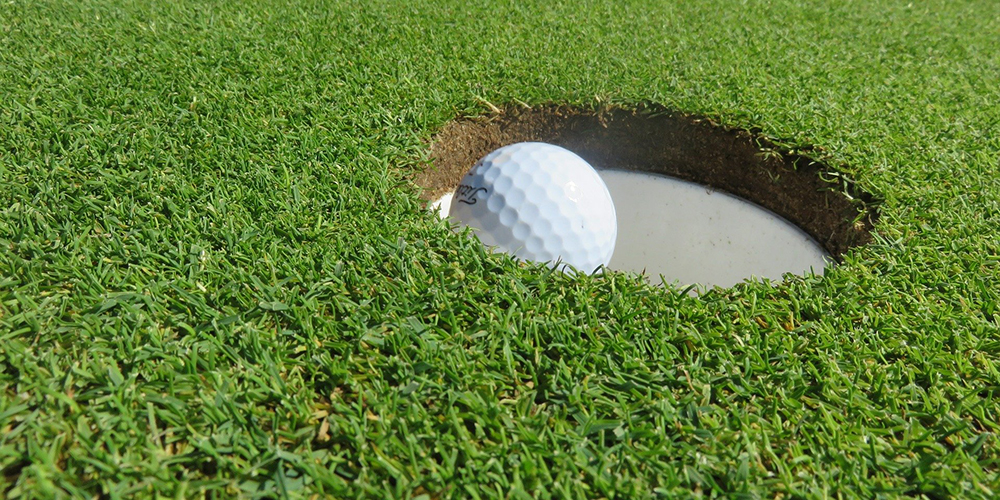 Golf Ball Going in Hole / Cup