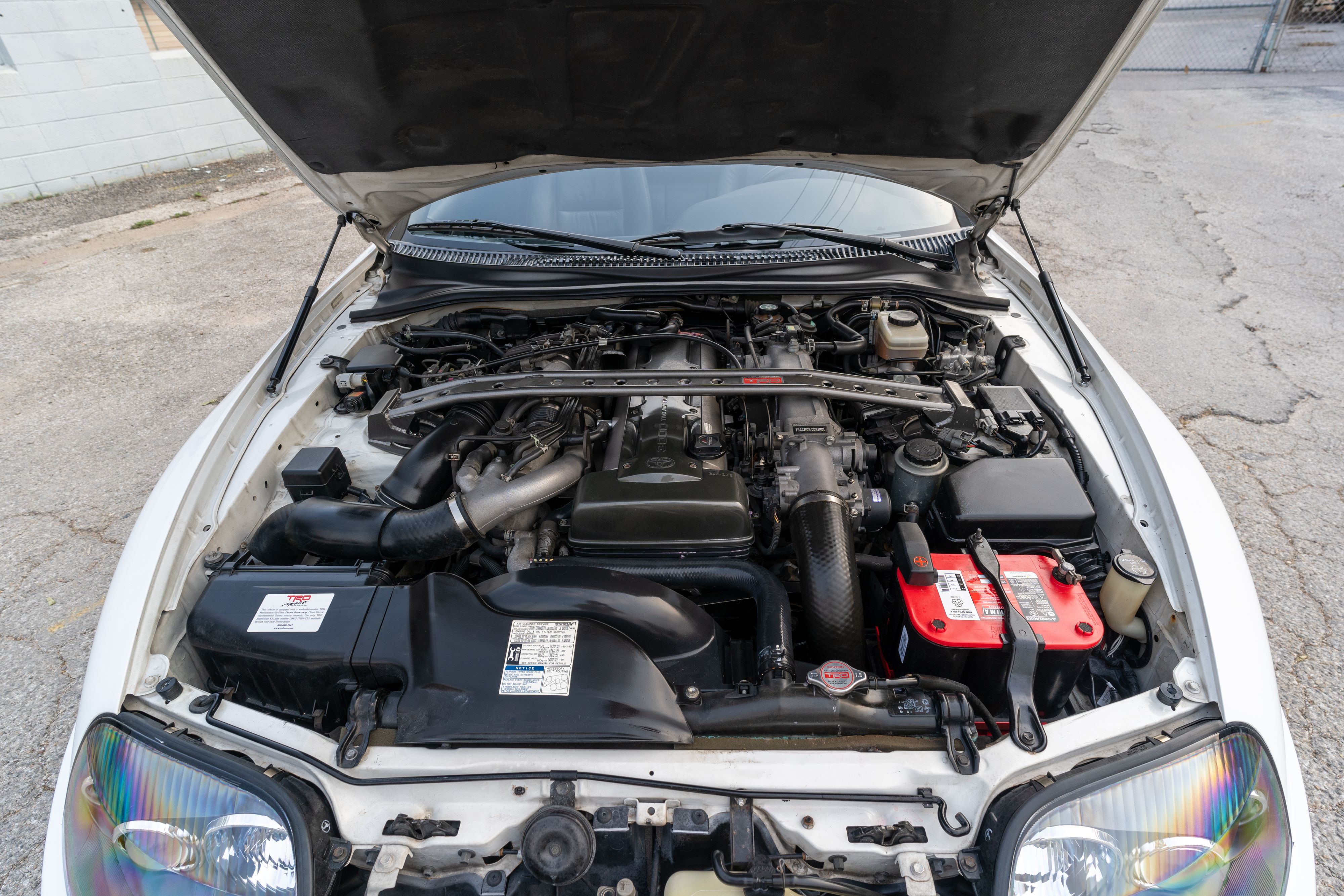 Engine bay of a White MK4 Toyota Supra in Austin, TX.