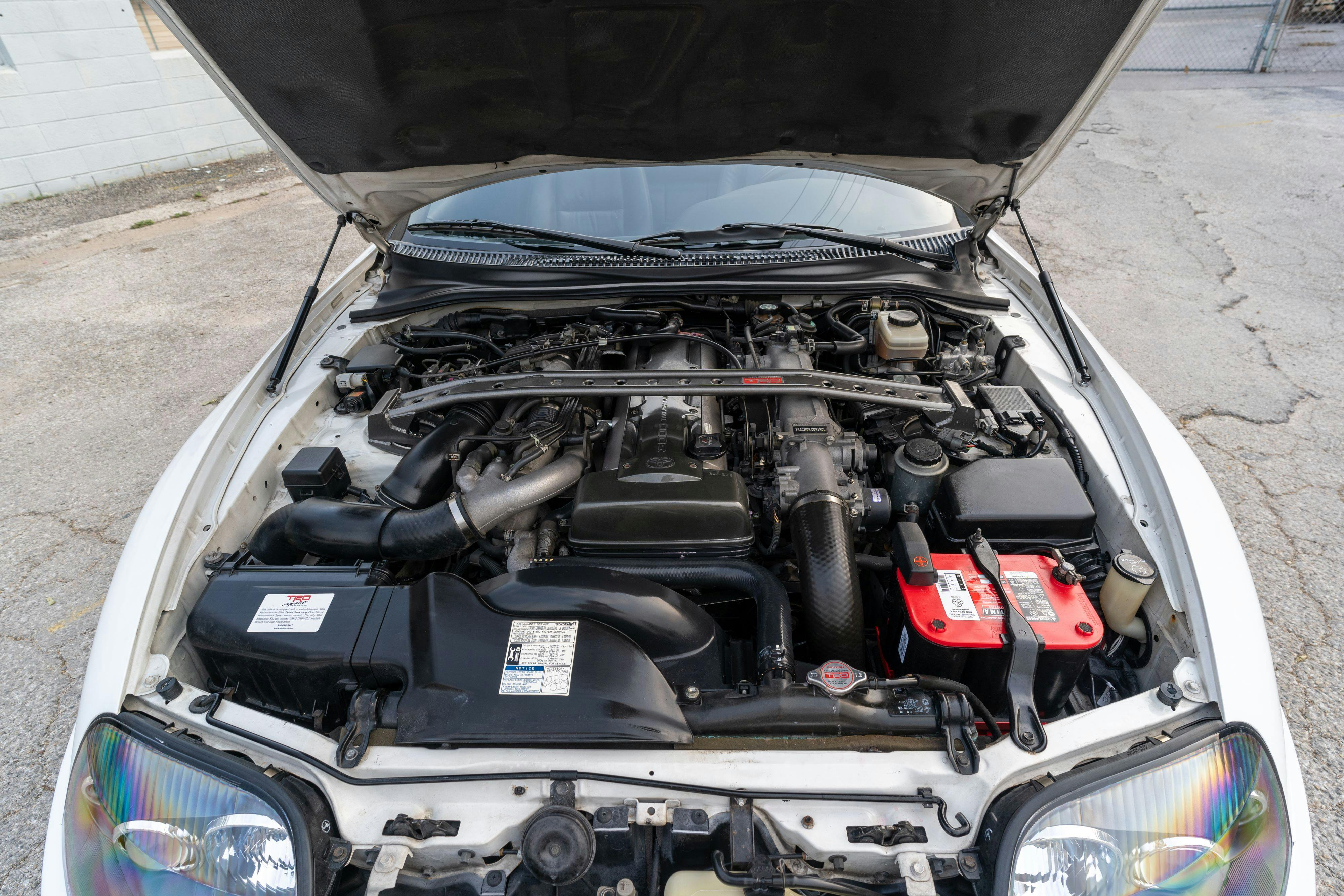 Engine bay of a White MK4 Toyota Supra in Austin, TX.