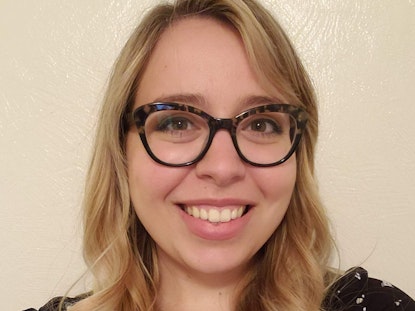Addie, a young white woman with cheetah glasses, smiles.