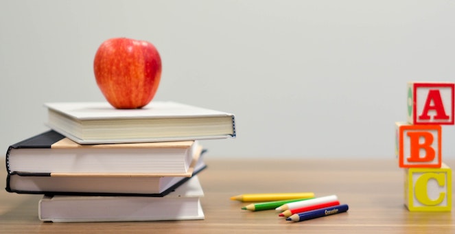 Apple on top of stack of books