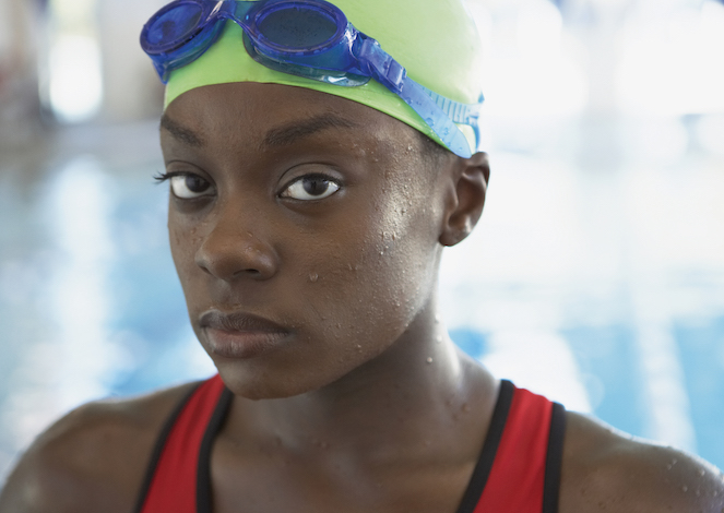 Young female swimmer posing seriously for the camera