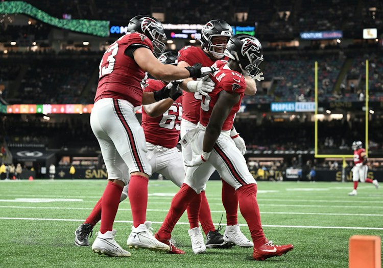Falcons running backs Bijan Robinson and Brian Robinson Jr. celebrate a touchdown against the Saints in New Orleans.