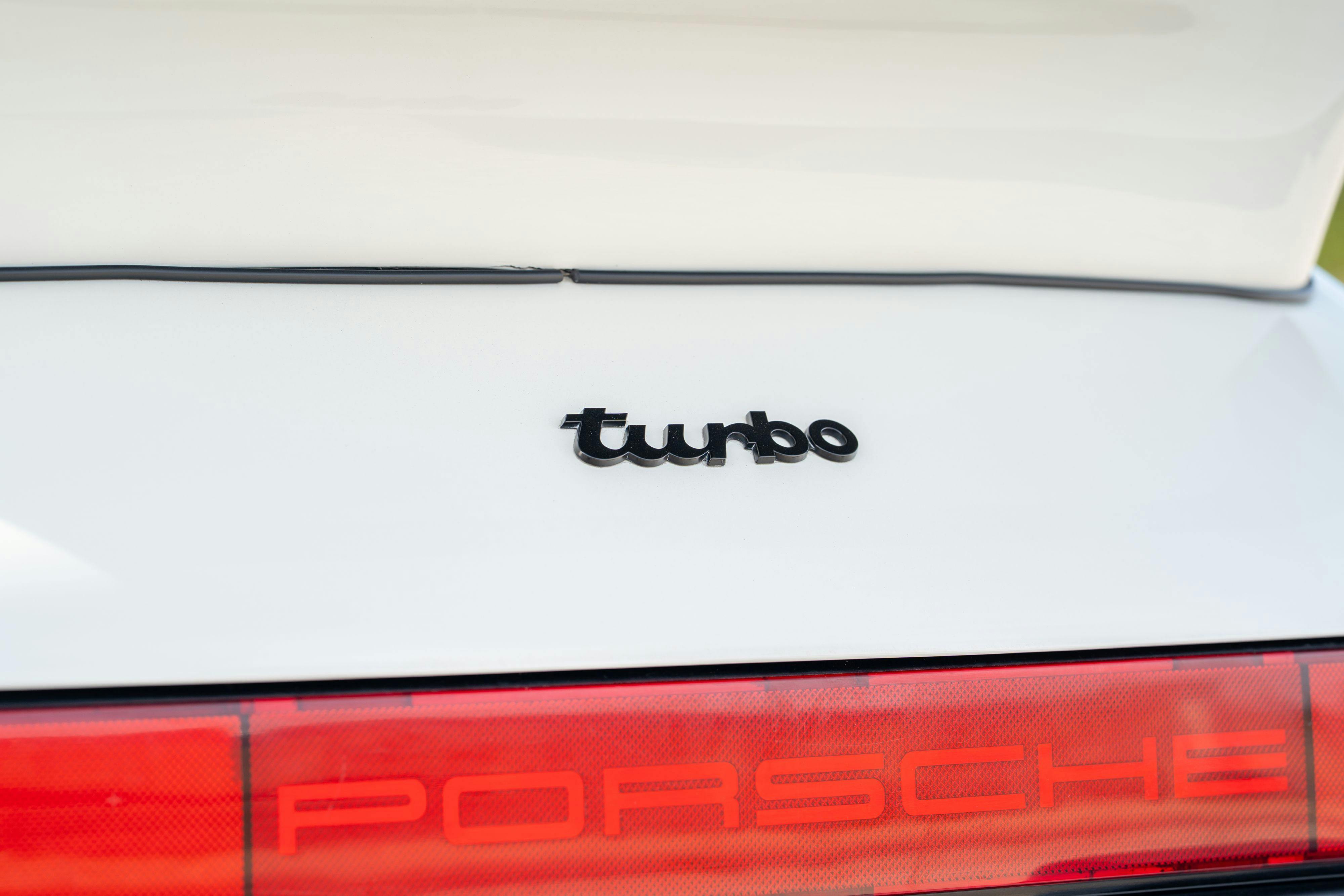1986 Porsche 930 Turbo badge in White on Black with the factory slatenose M505 option.
