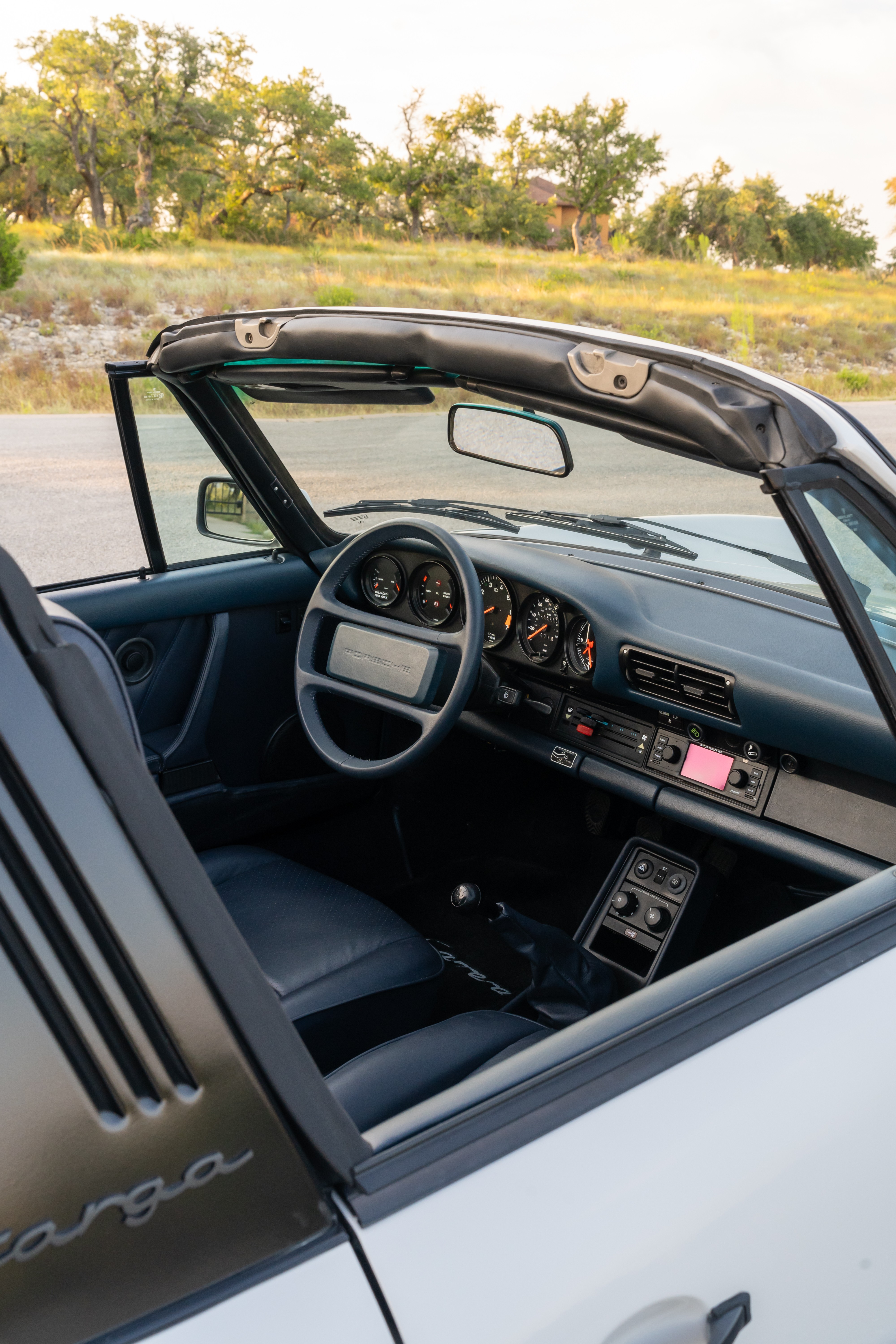 Marble Grey 1986 Porsche 911 Carrera Targa with blue interior shot in Austin, TX.