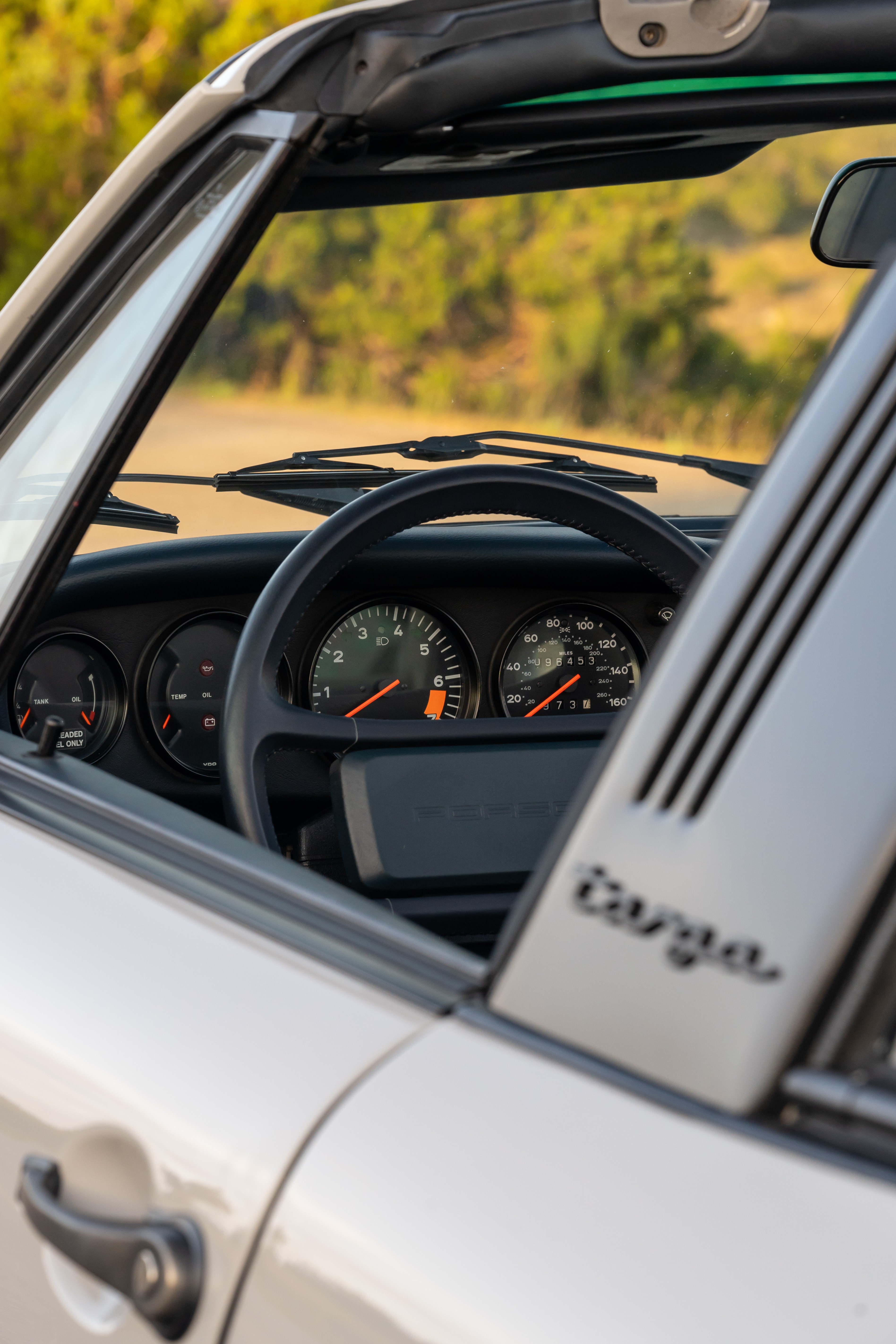 Marble Grey 1986 Porsche 911 Carrera Targa with blue interior shot in Austin, TX.