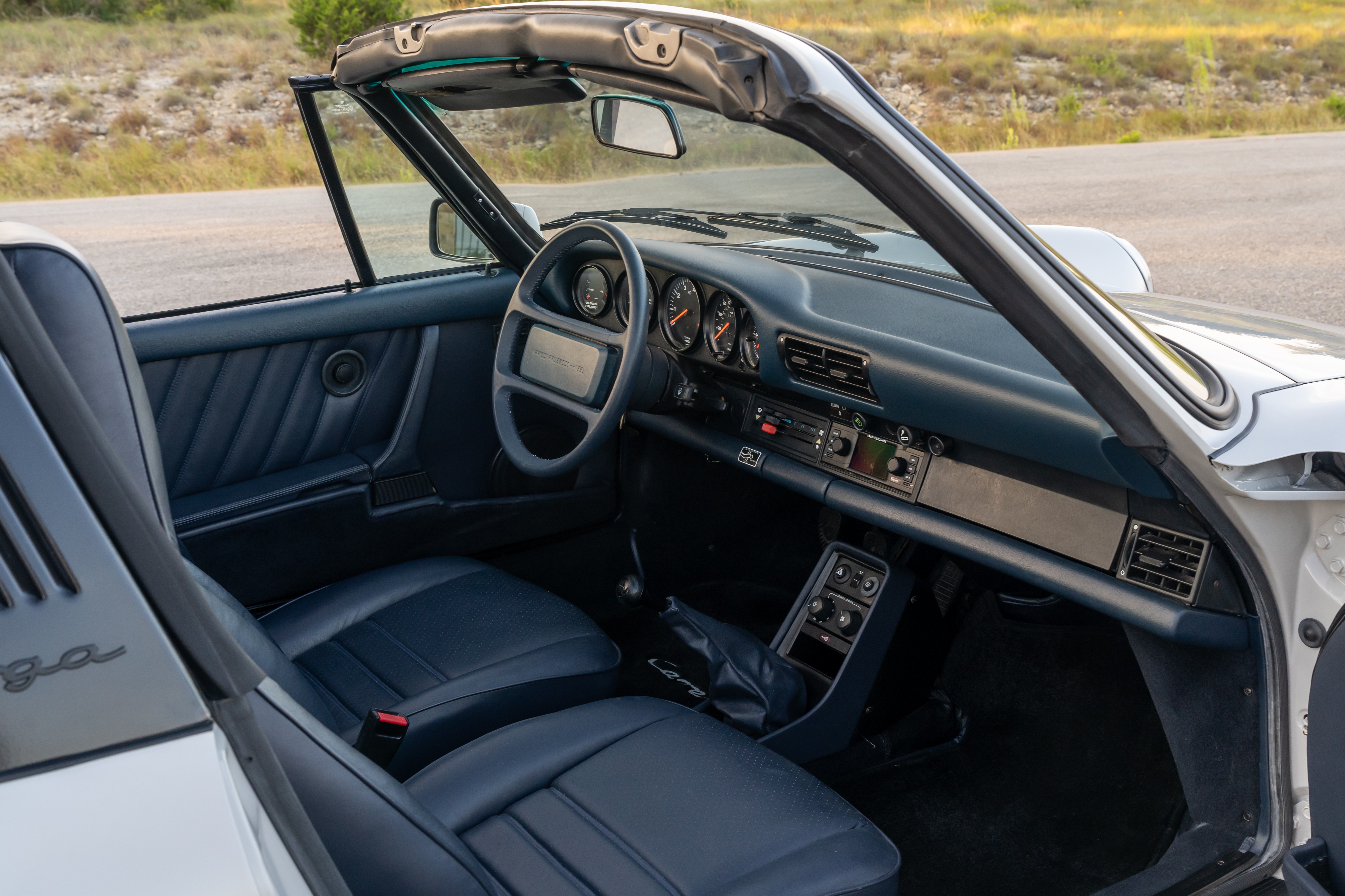 Marble Grey 1986 Porsche 911 Carrera Targa with blue interior shot in Austin, TX.