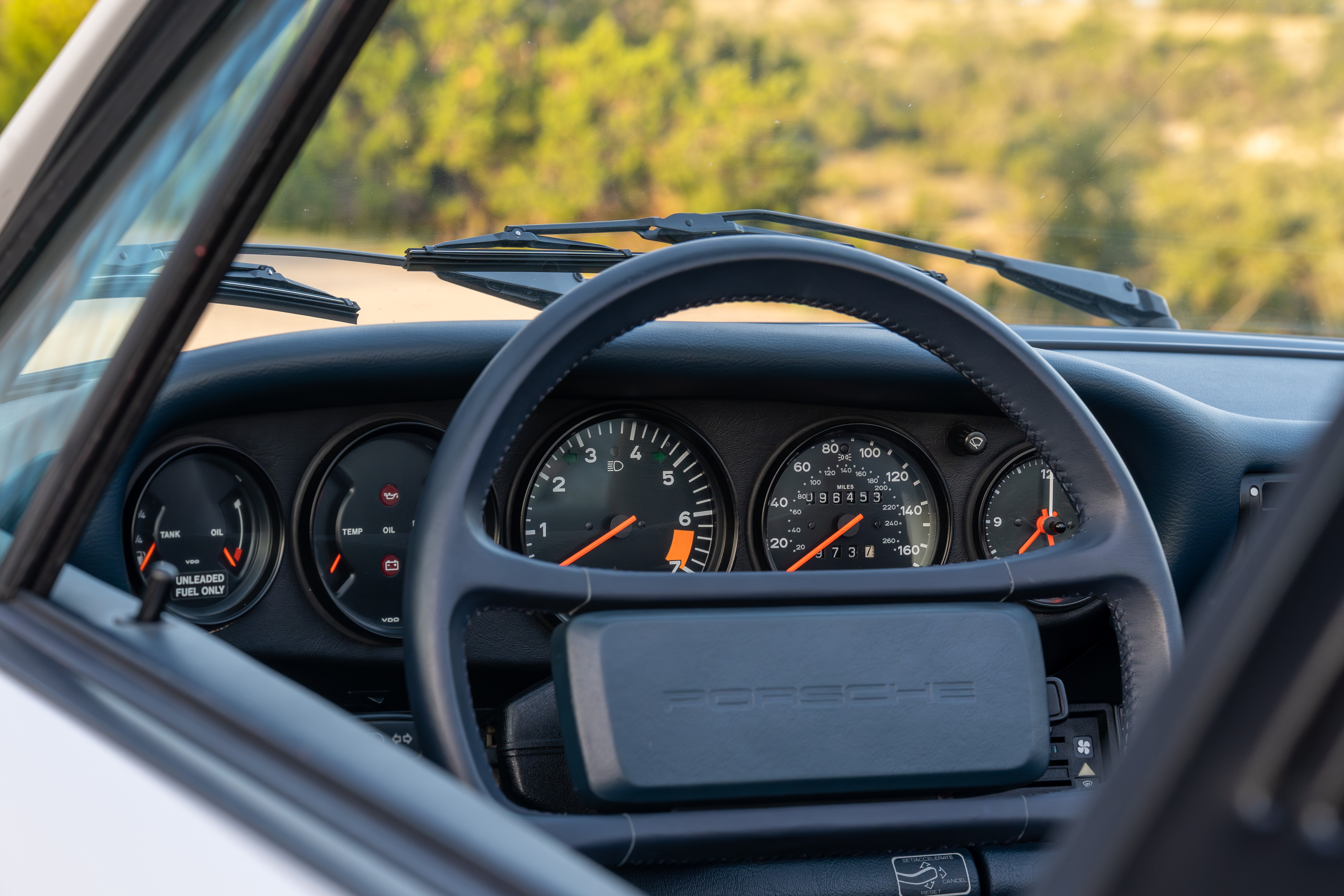 Marble Grey 1986 Porsche 911 Carrera Targa with blue interior shot in Austin, TX.