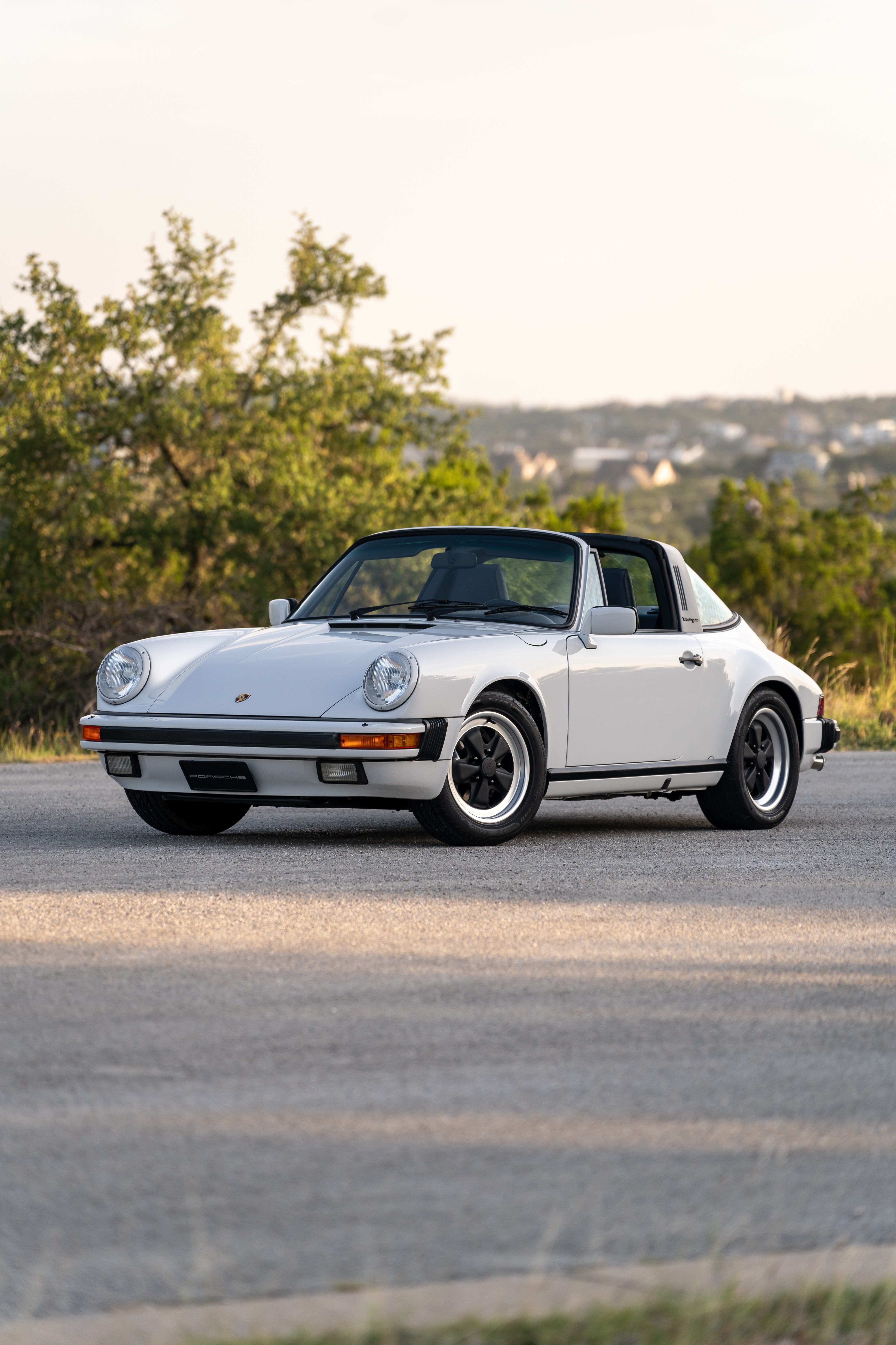 Marble Grey 1986 Porsche 911 Carrera Targa with blue interior shot in Austin, TX.