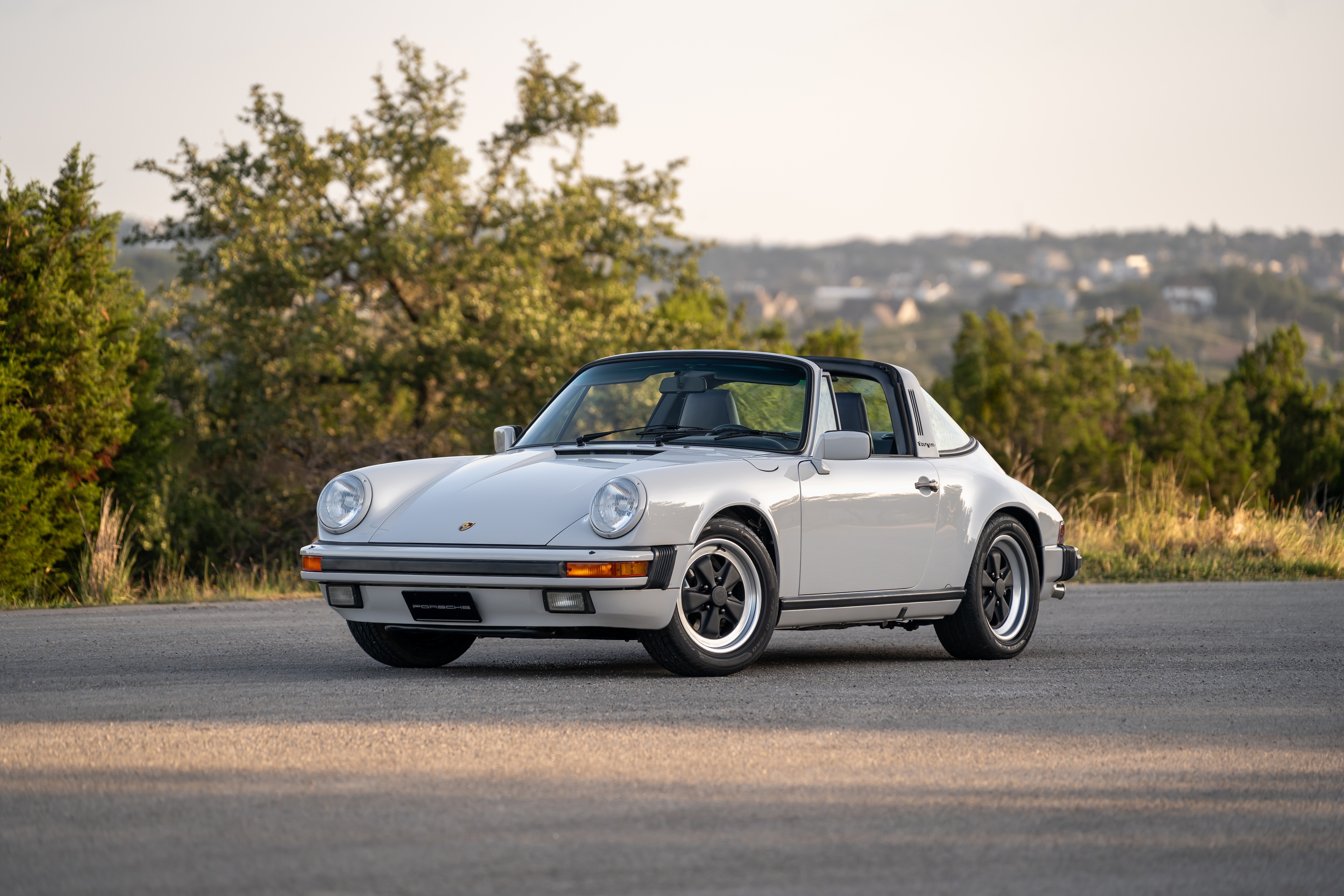 Marble Grey 1986 Porsche 911 Carrera Targa with blue interior shot in Austin, TX.