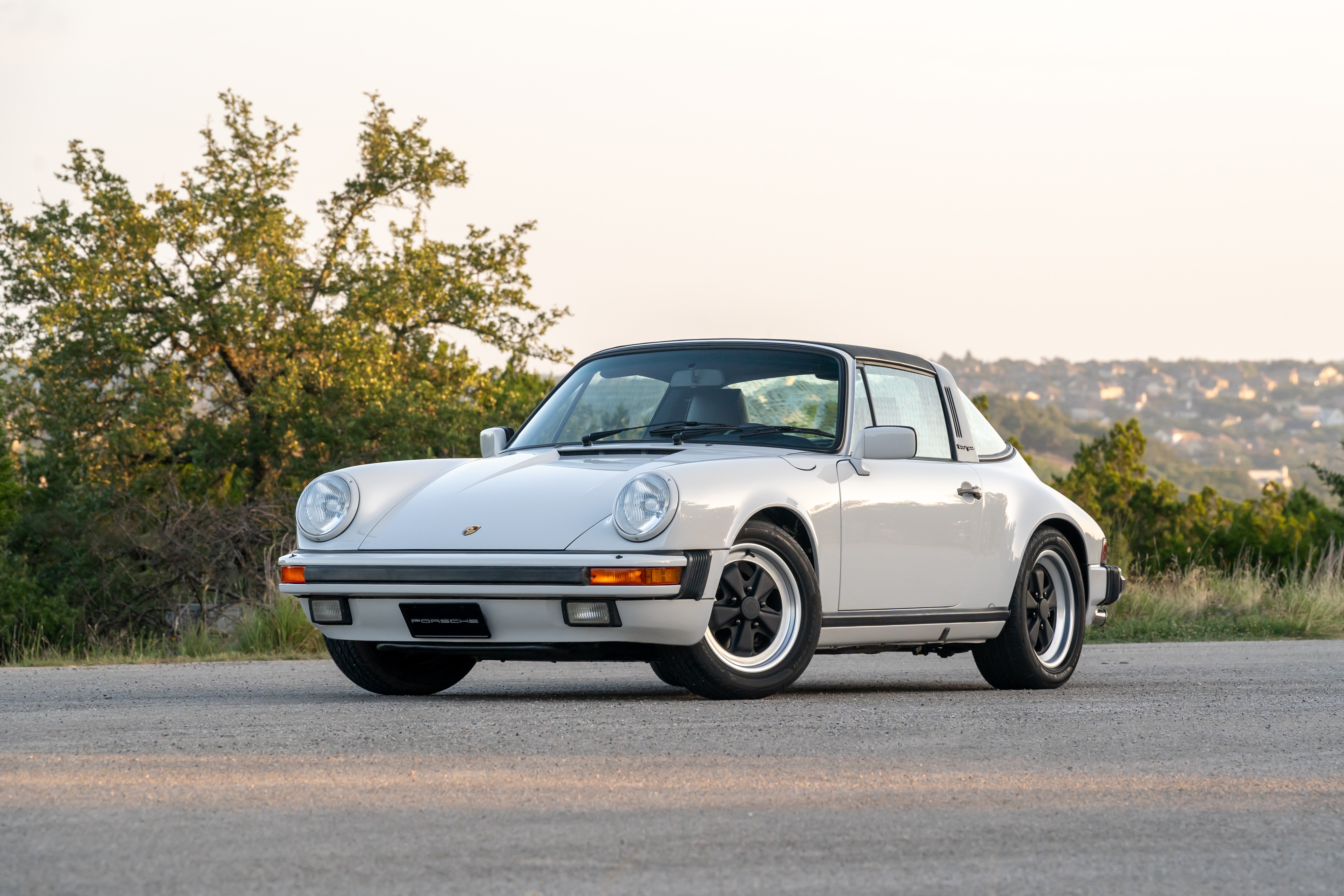 Marble Grey 1986 Porsche 911 Carrera Targa with blue interior shot in Austin, TX.