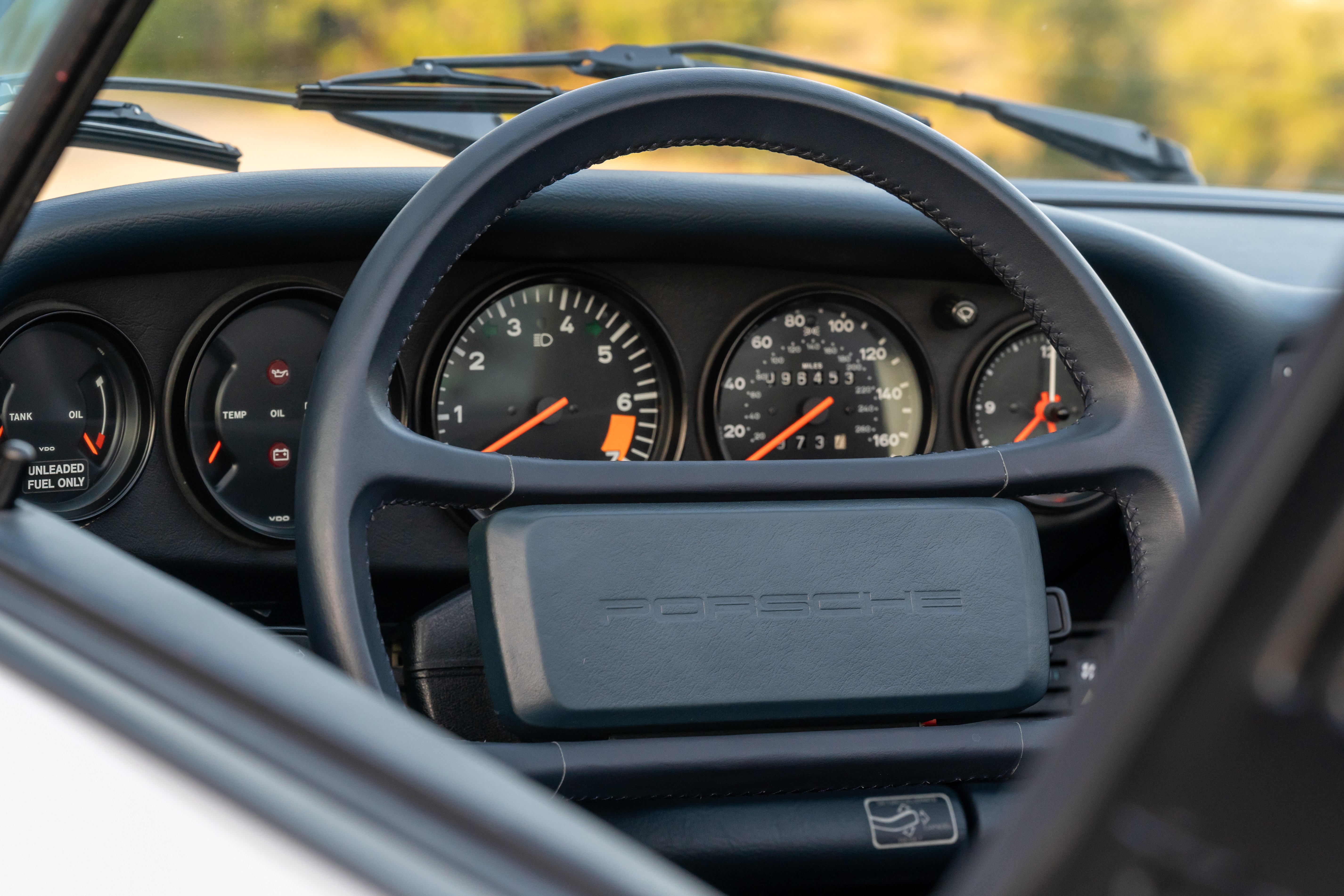 Marble Grey 1986 Porsche 911 Carrera Targa with blue interior shot in Austin, TX.