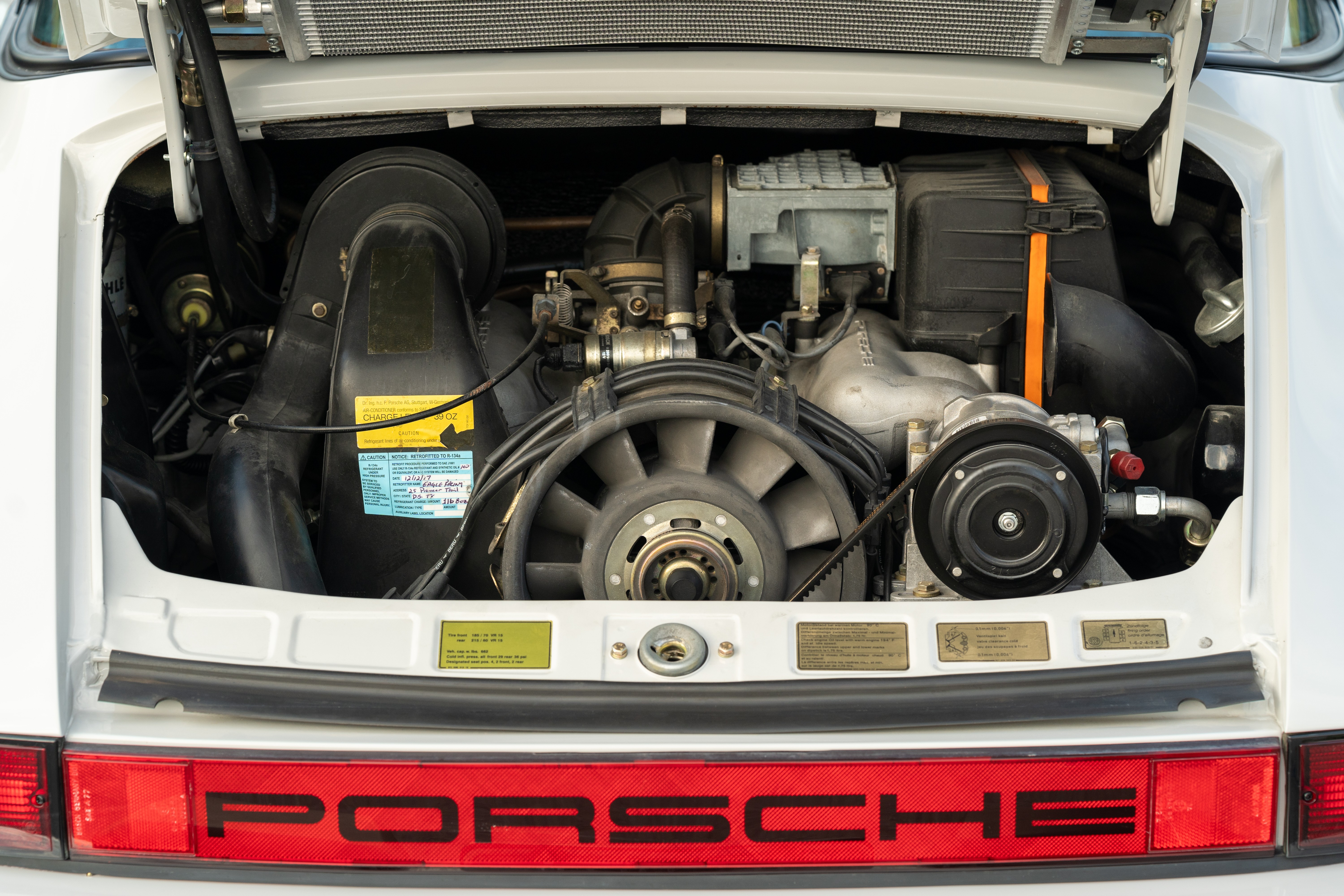 Engine bay in a Marble Grey 1986 Porsche 911 Carrera Targa with blue interior shot in Austin, TX.