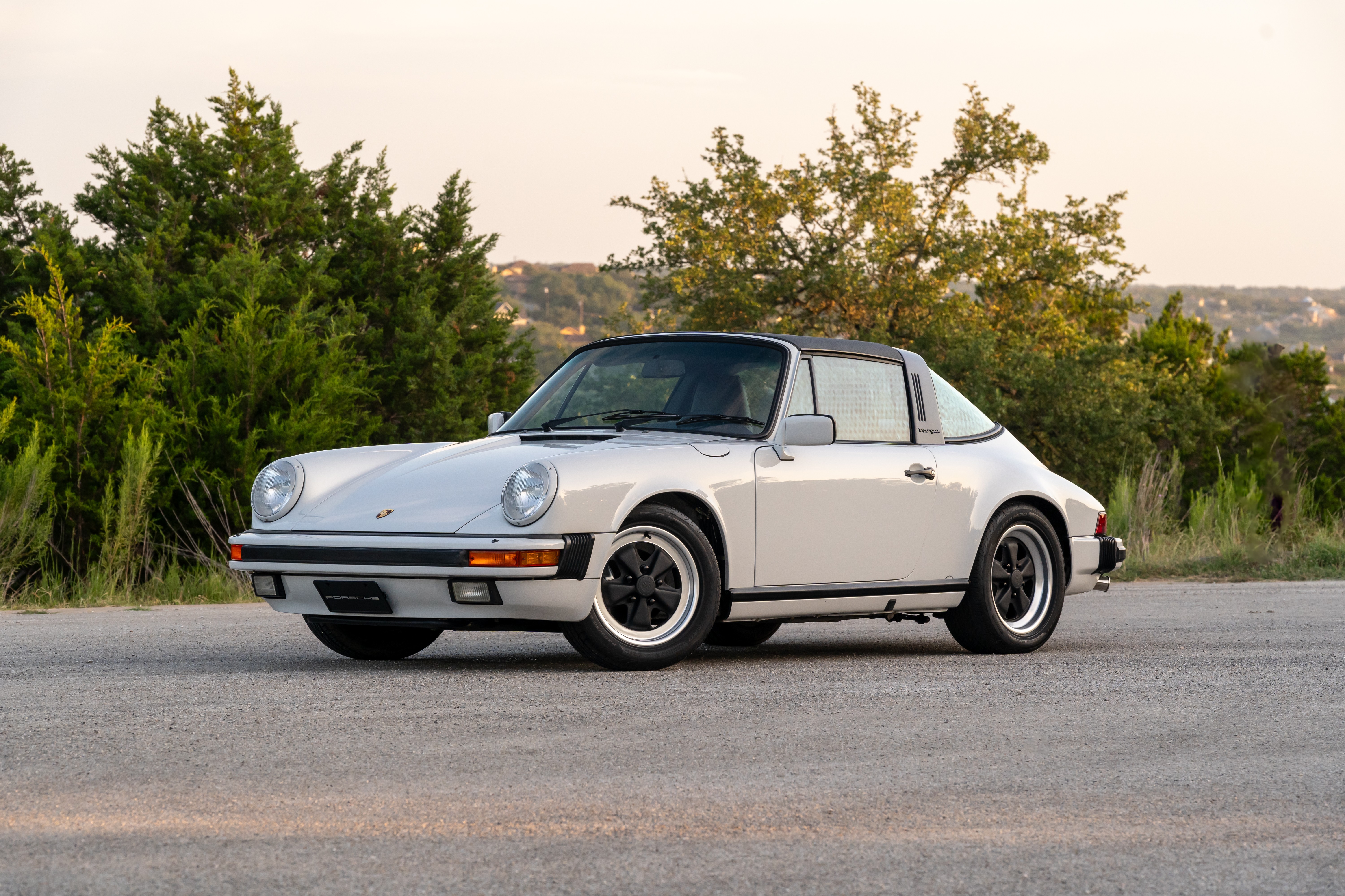 Marble Grey 1986 Porsche 911 Carrera Targa with blue interior shot in Austin, TX.