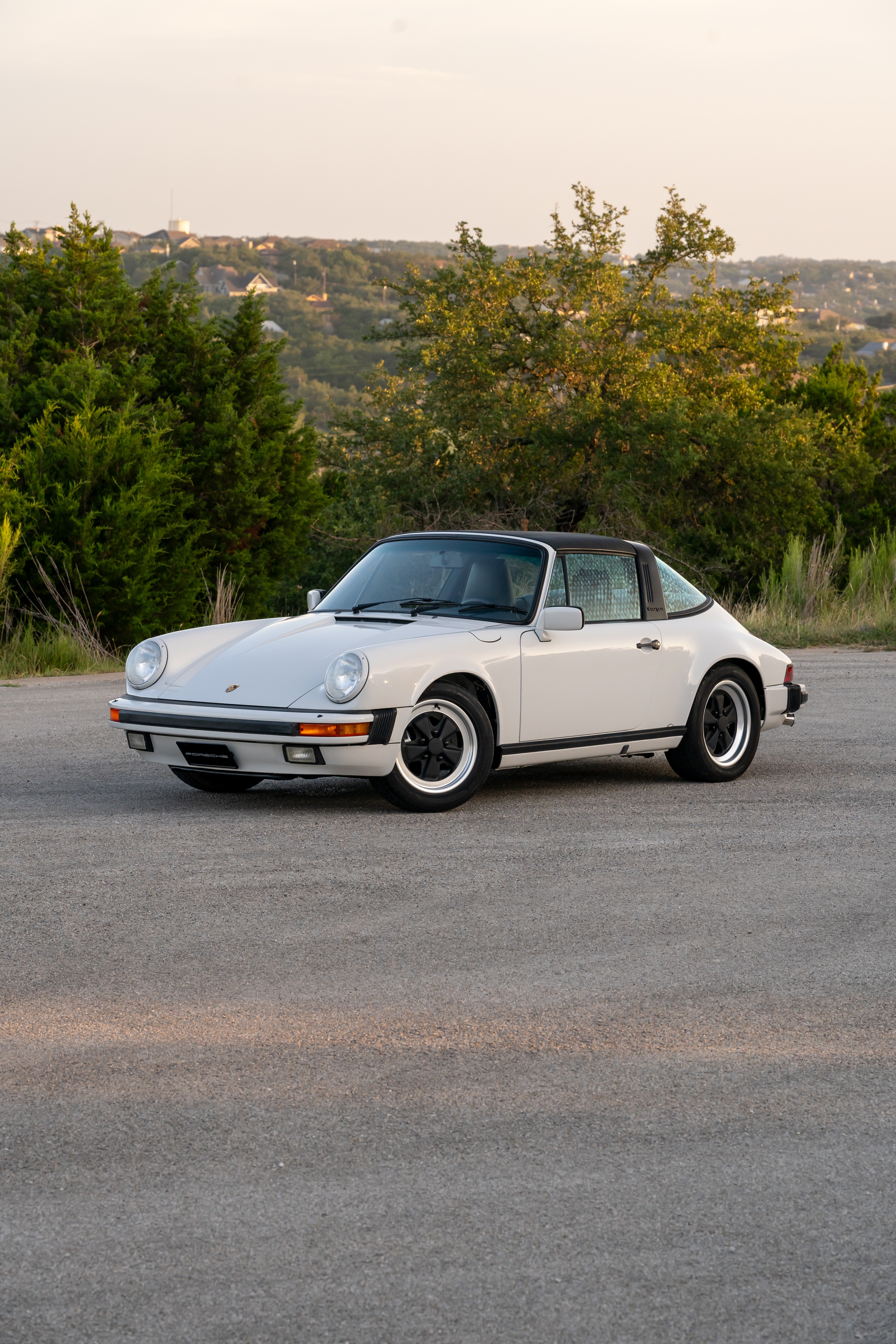 Marble Grey 1986 Porsche 911 Carrera Targa with blue interior shot in Austin, TX.