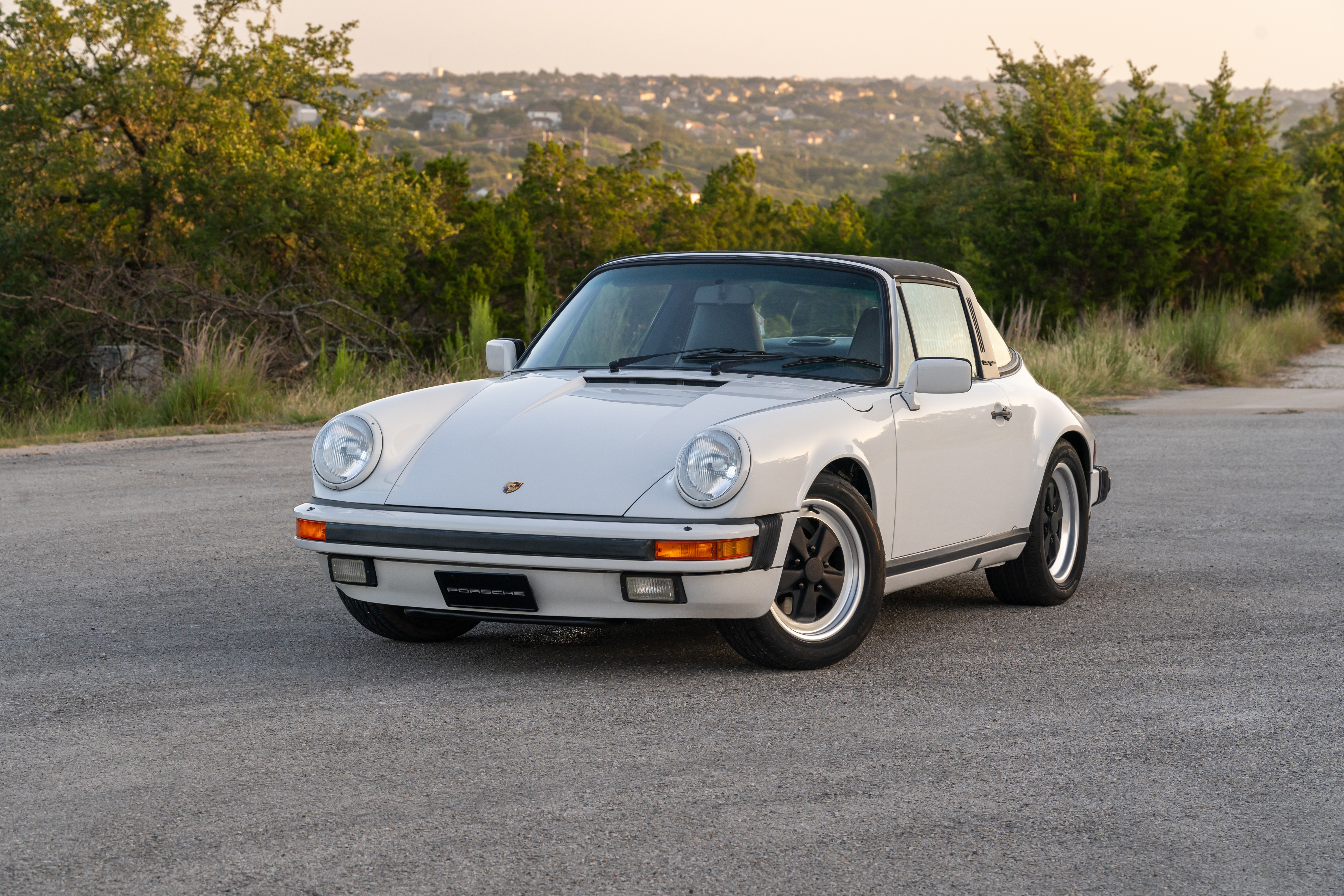 Marble Grey 1986 Porsche 911 Carrera Targa with blue interior shot in Austin, TX.