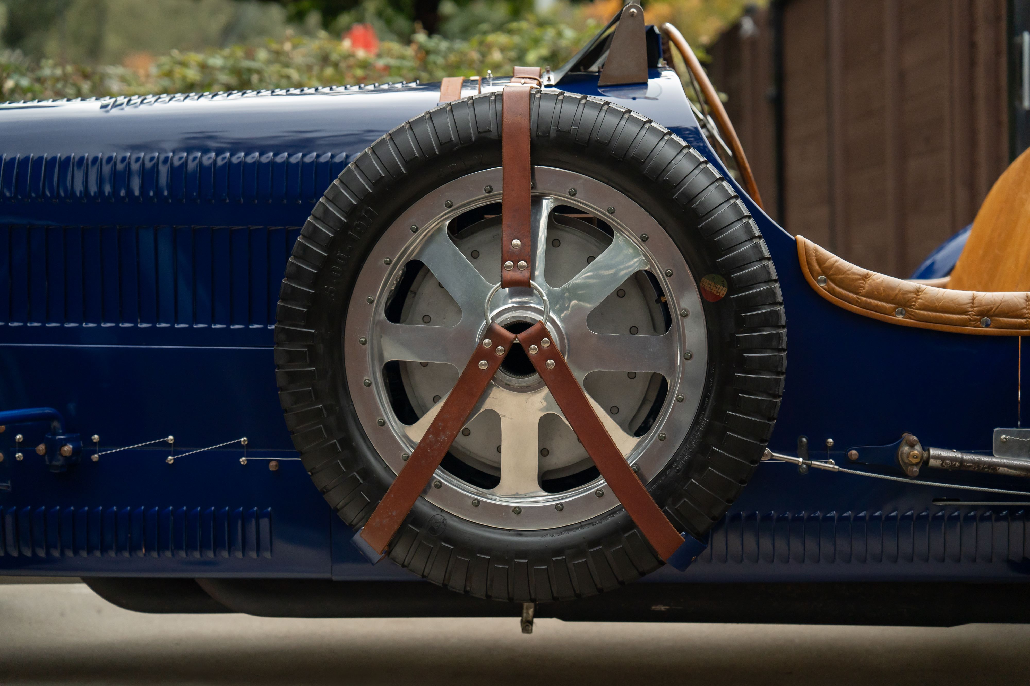 Spare tire on a Pur Sang Bugatti Type 35 in Blue over Brown shot in Austin, TX.