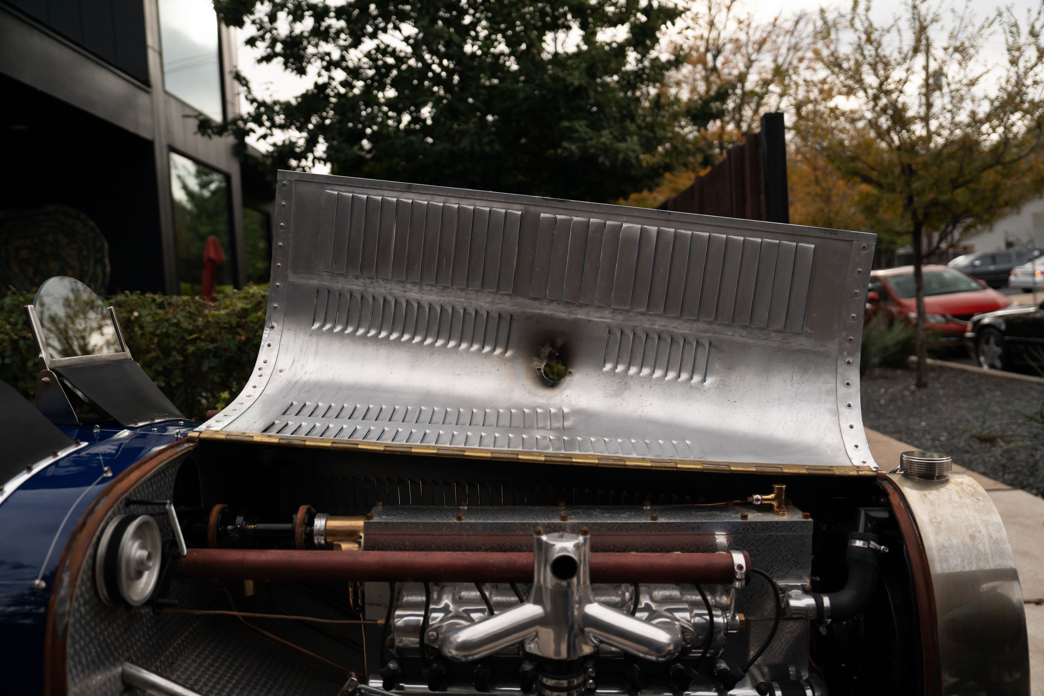 Open engine cover of a Pur Sang Bugatti Type 35 in Blue over Brown shot in Austin, TX.