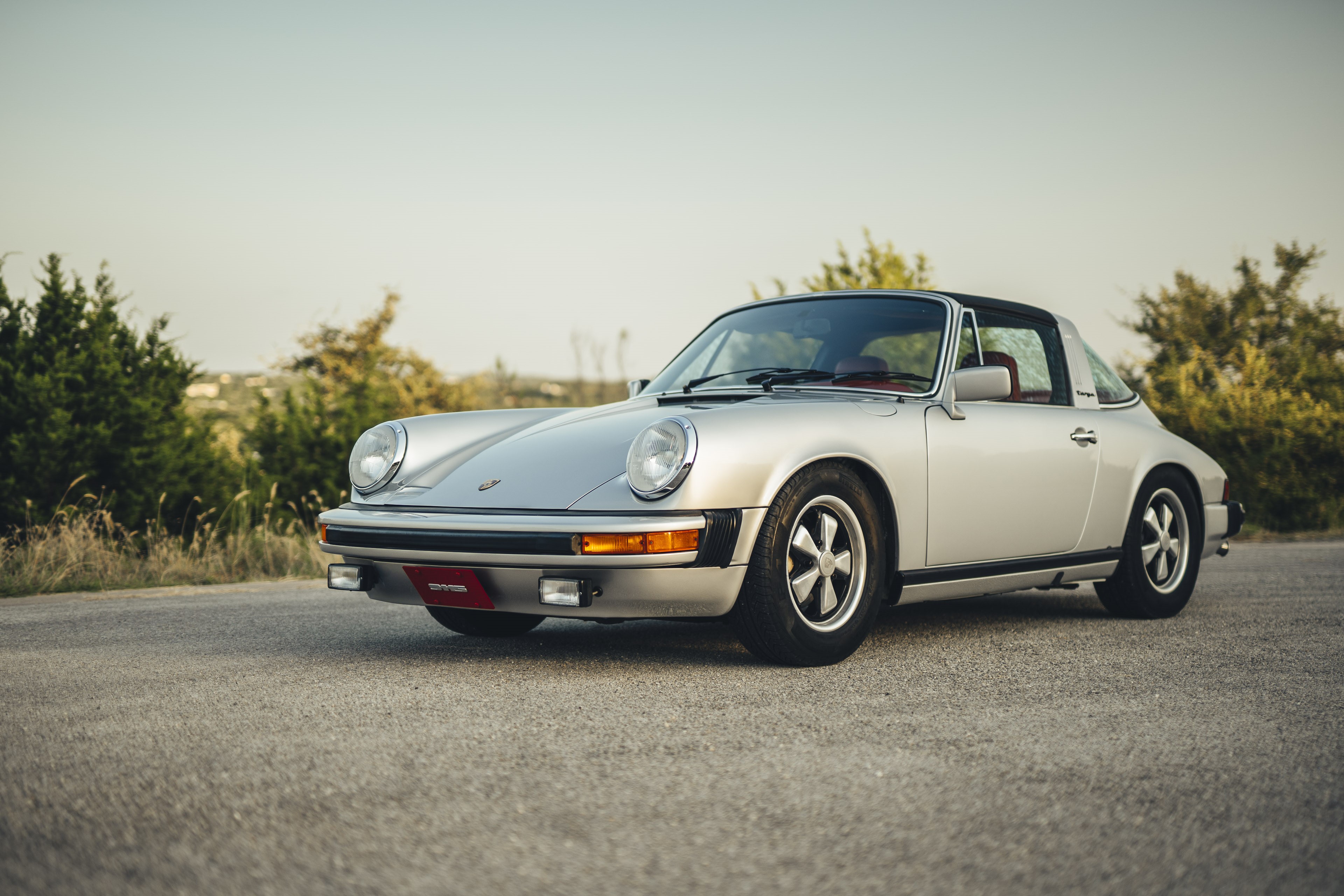 Silver on red Porsche 911S.