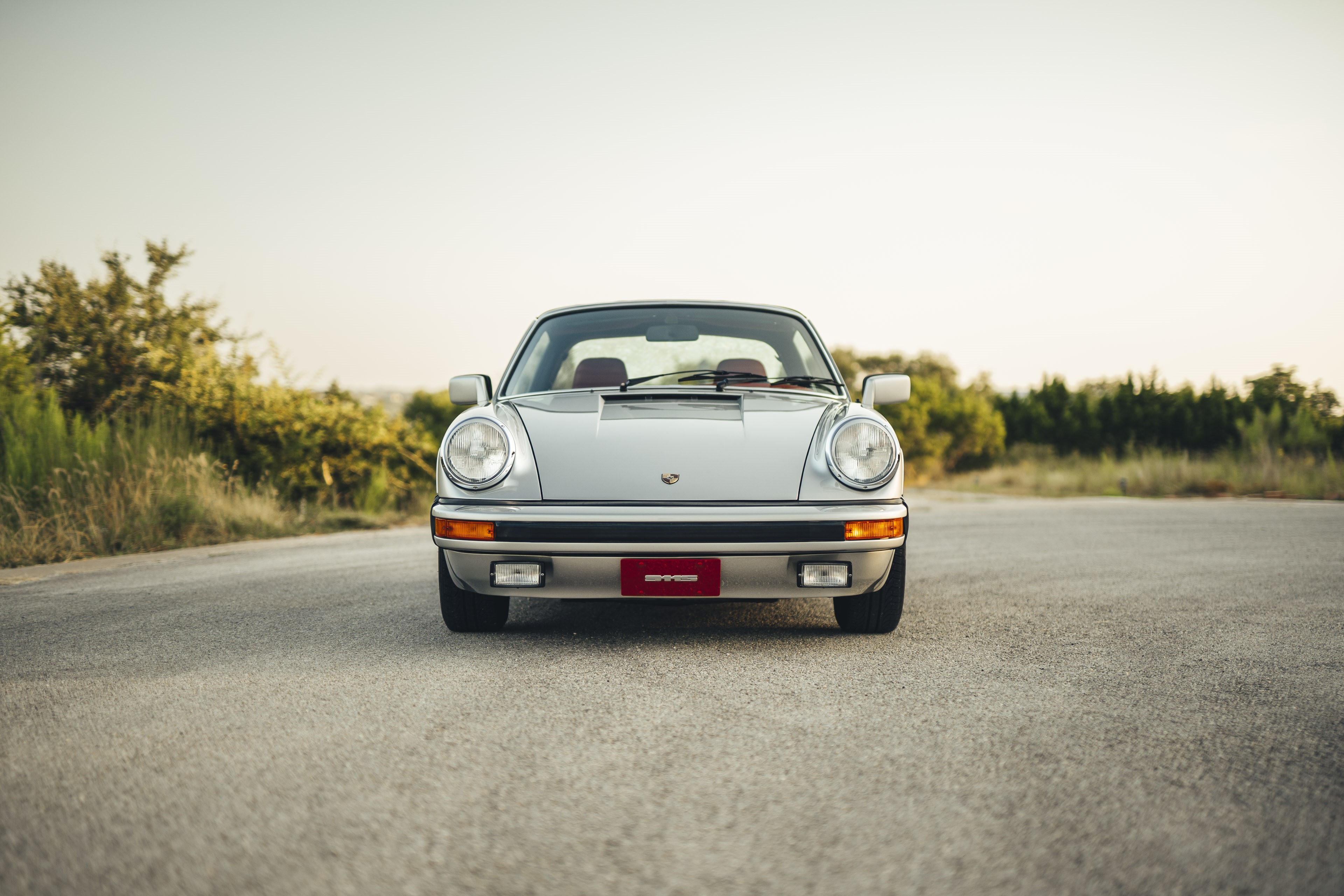 Frontend of a silver on red Porsche 911S.